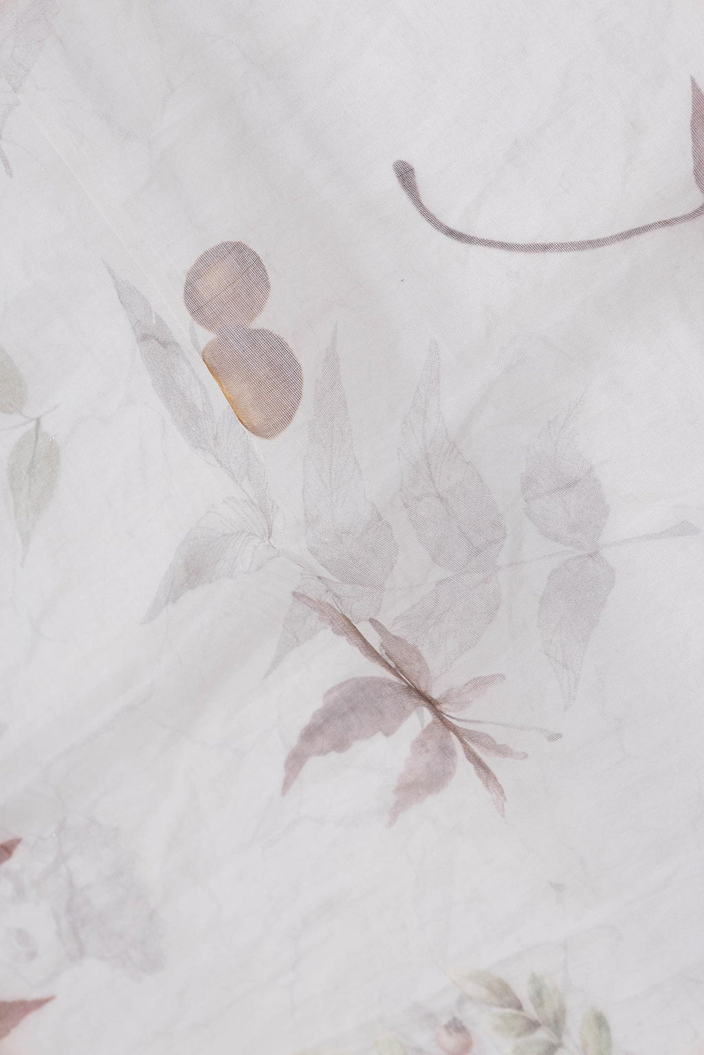 Close up of Off White Dual Tone Linen Saree with Printed design on the body and Without Border.  displaying folds
