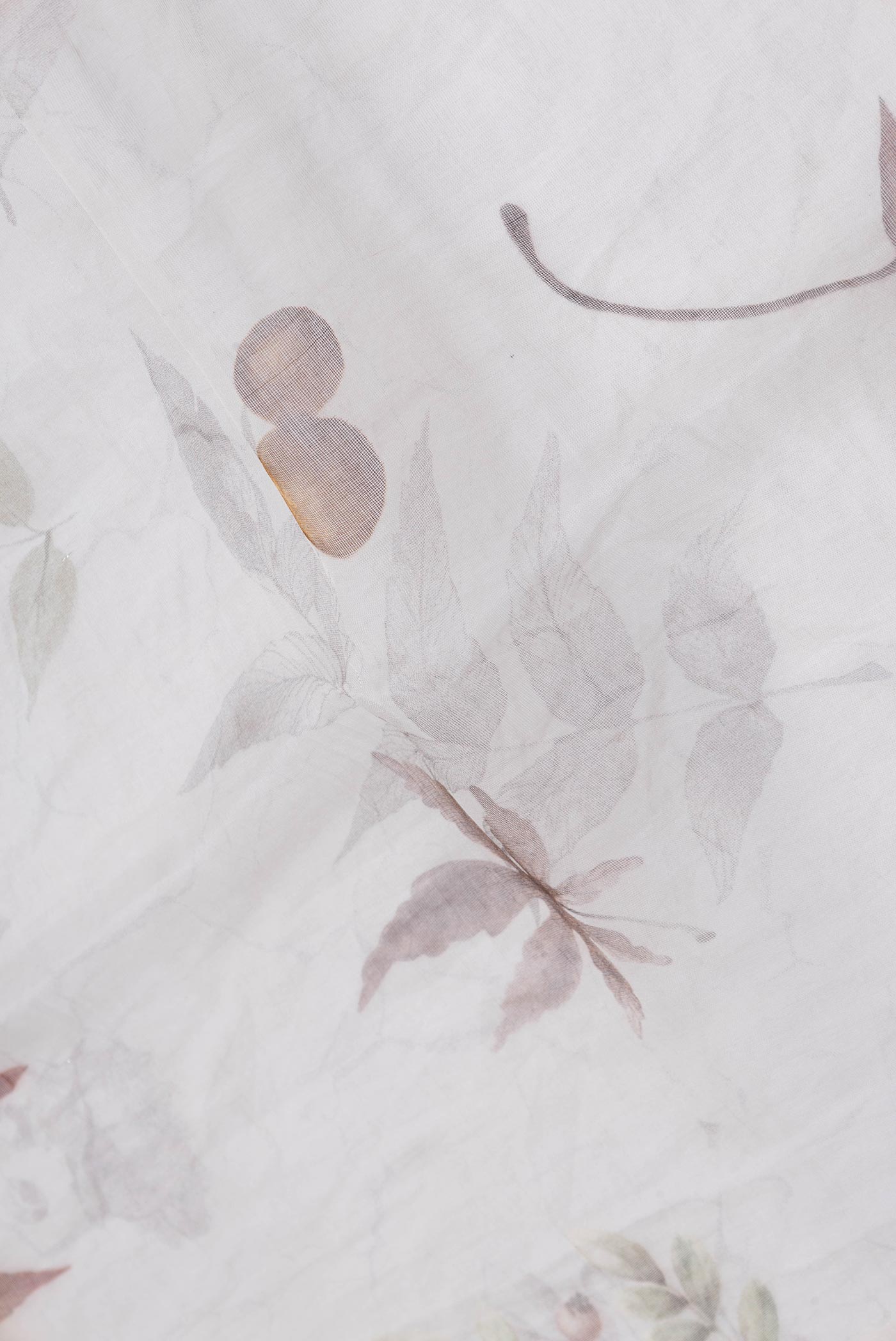 Close up of Off White Dual Tone Linen Saree with Printed design on the body and Without Border.  displaying folds