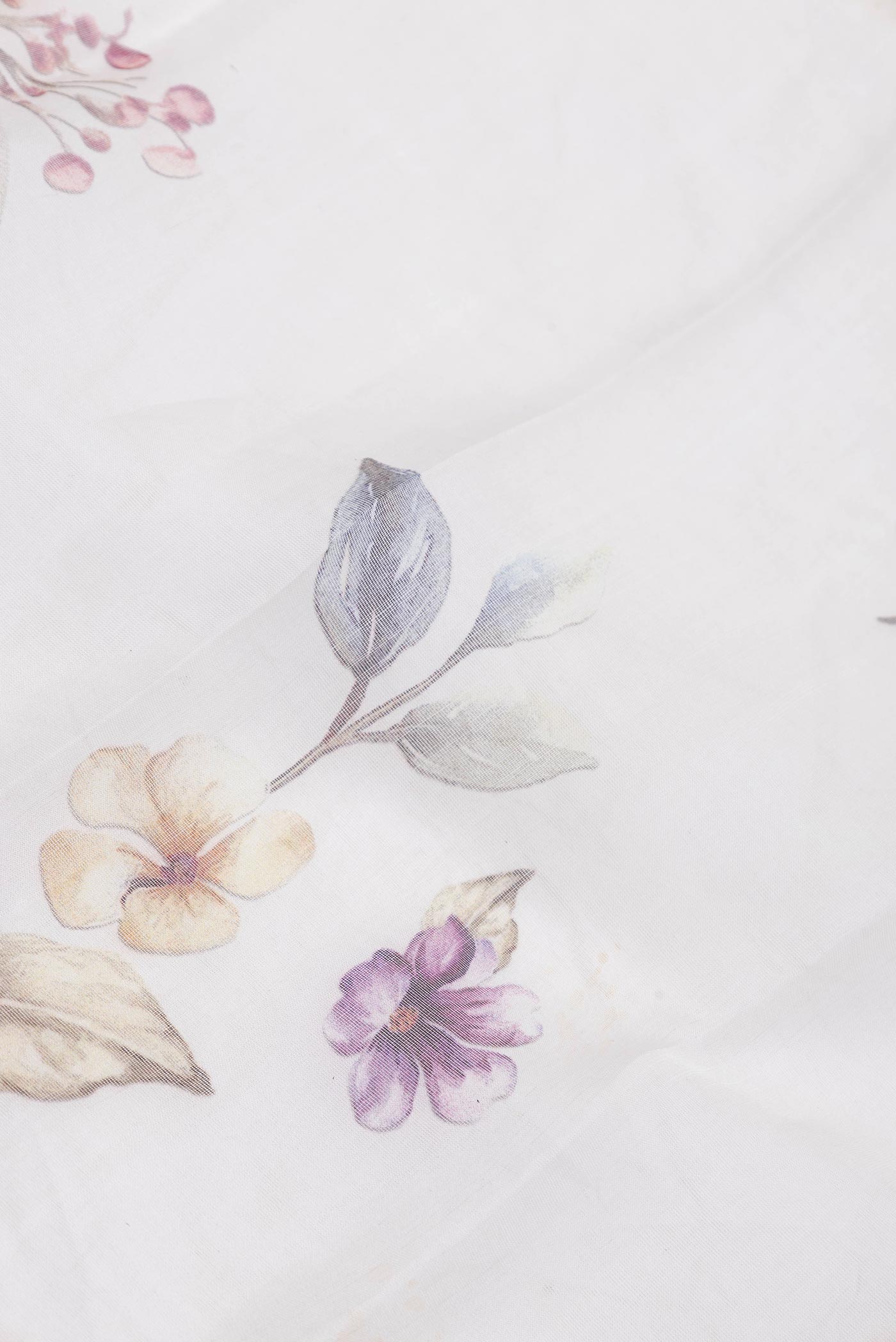 Close up of Off White Dual Tone Linen Saree with Printed design on the body and Without Border.  displaying folds