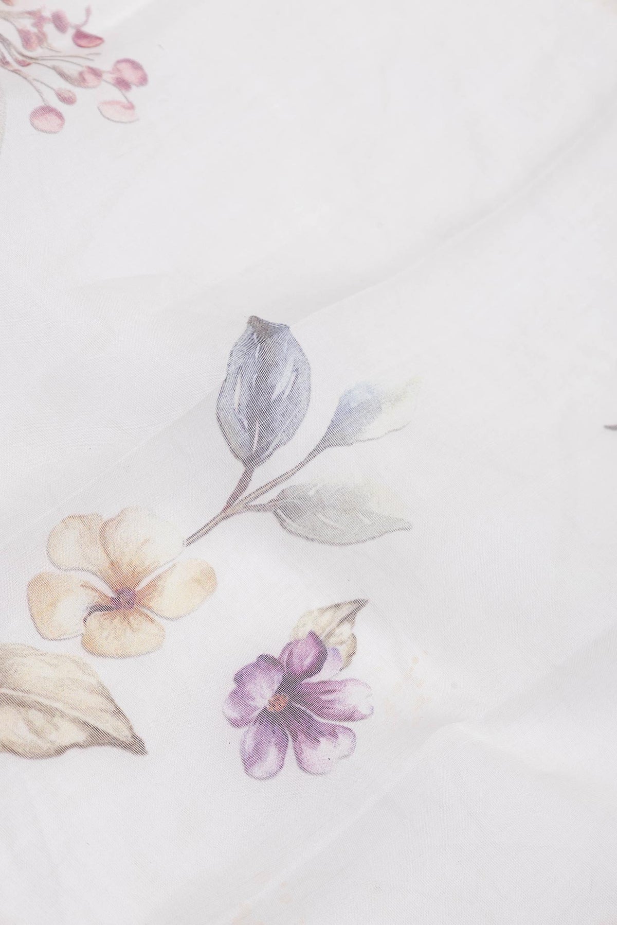 Close up of Off White Dual Tone Linen Saree with Printed design on the body and Without Border.  displaying folds