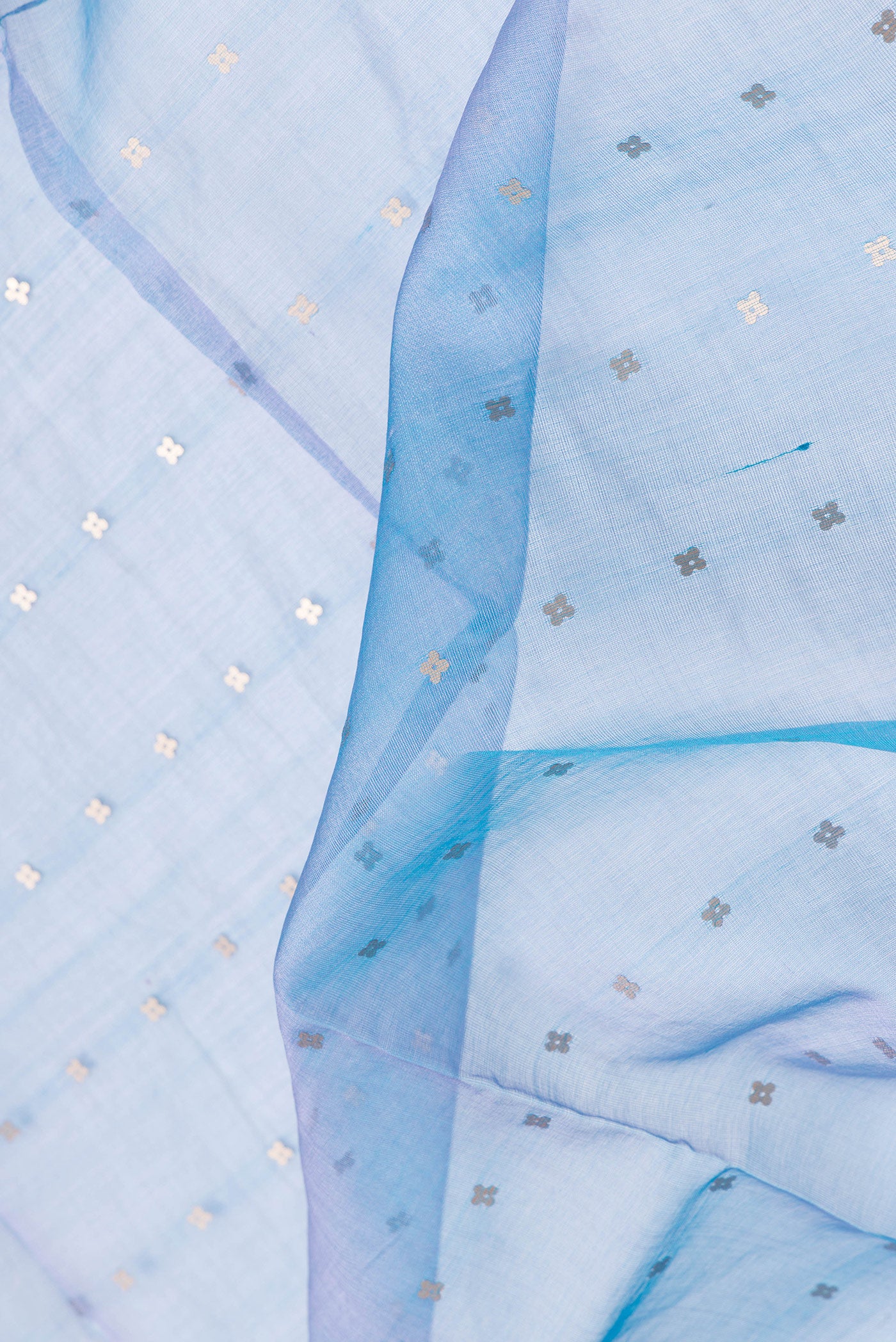 Close up of Peacock Blue Dual Tone Tussar Silk Saree with Embroidery on the body and Zari Border.  displaying folds