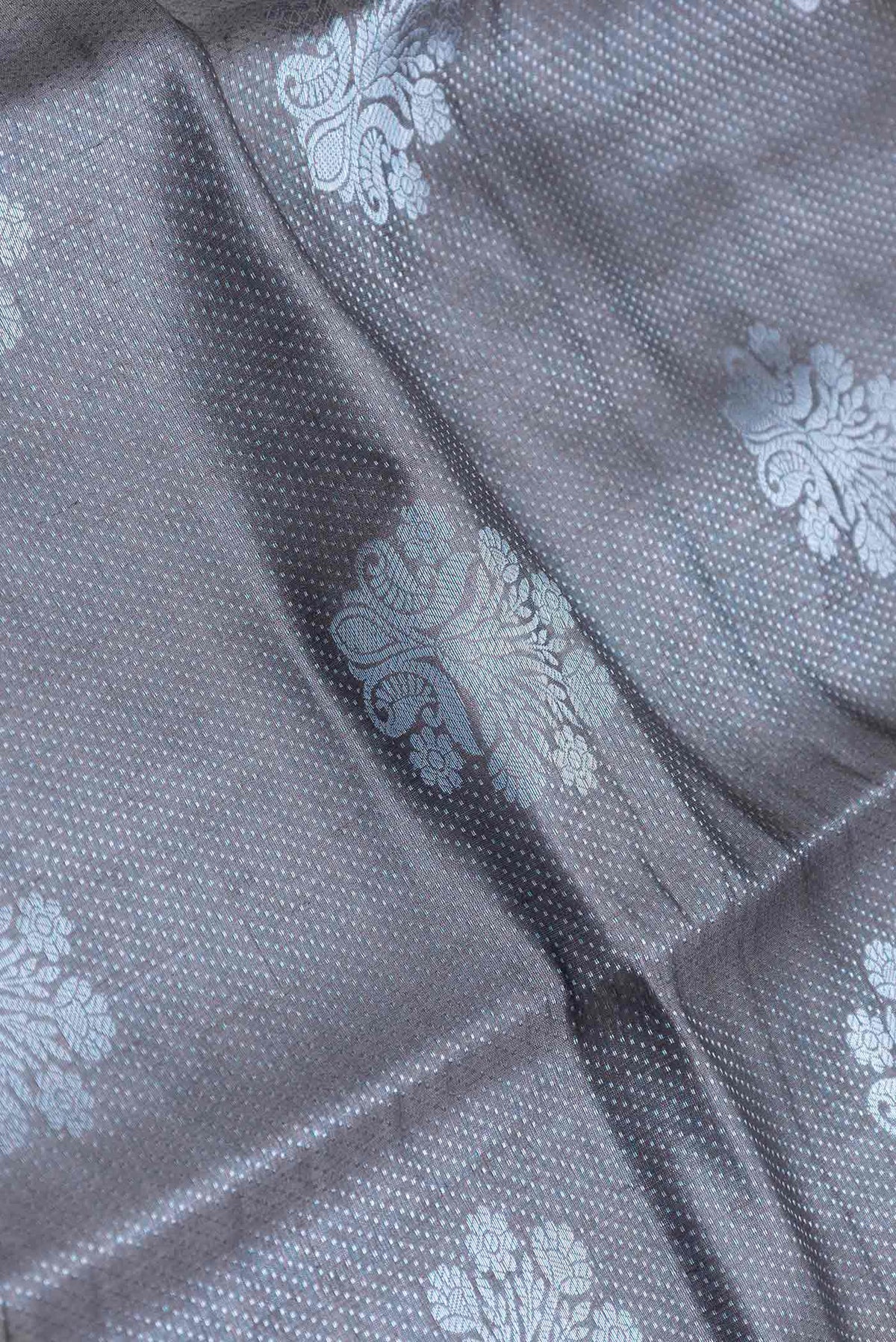 Close up of Grey Banarasi Raw Silk Saree with Zari Brocade on the body and Zari Border displaying folds