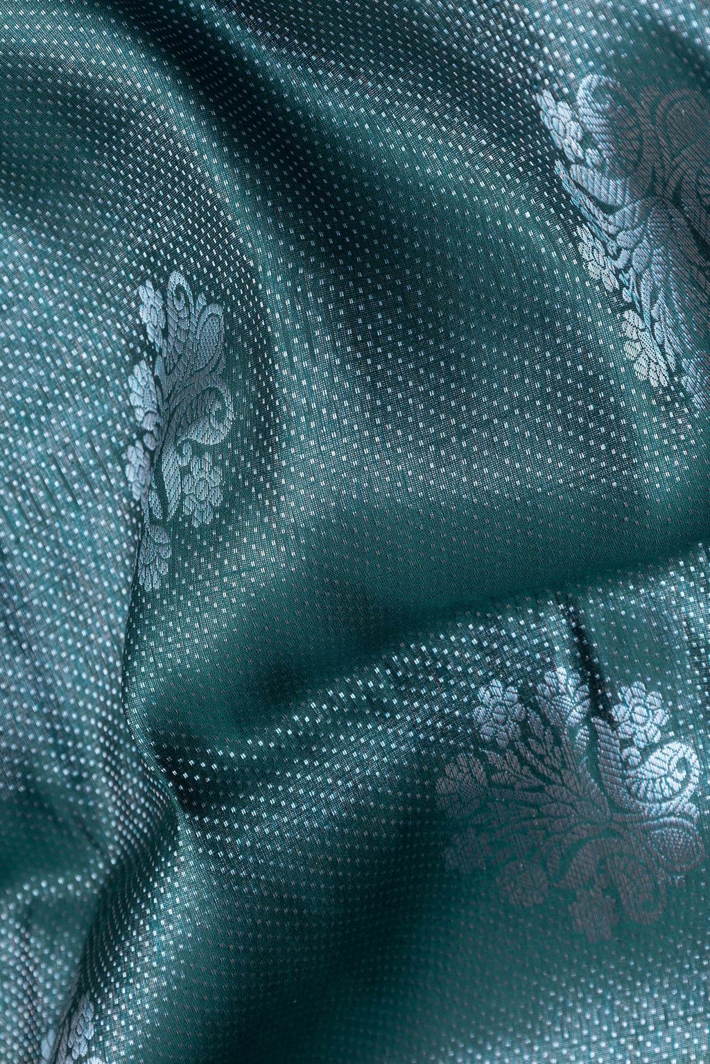 Close up of Peacock Blue Dual Tone Tussar Silk Saree with Zari Brocade on the body and Zari Border.  displaying folds