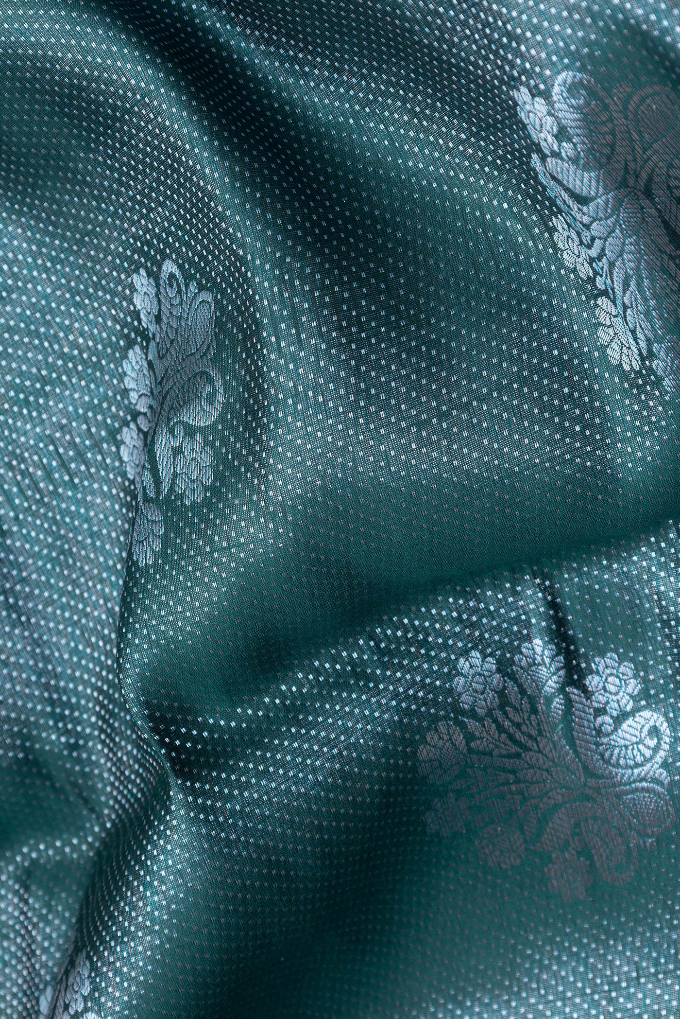 Close up of Peacock Blue Dual Tone Tussar Silk Saree with Zari Brocade on the body and Zari Border.  displaying folds