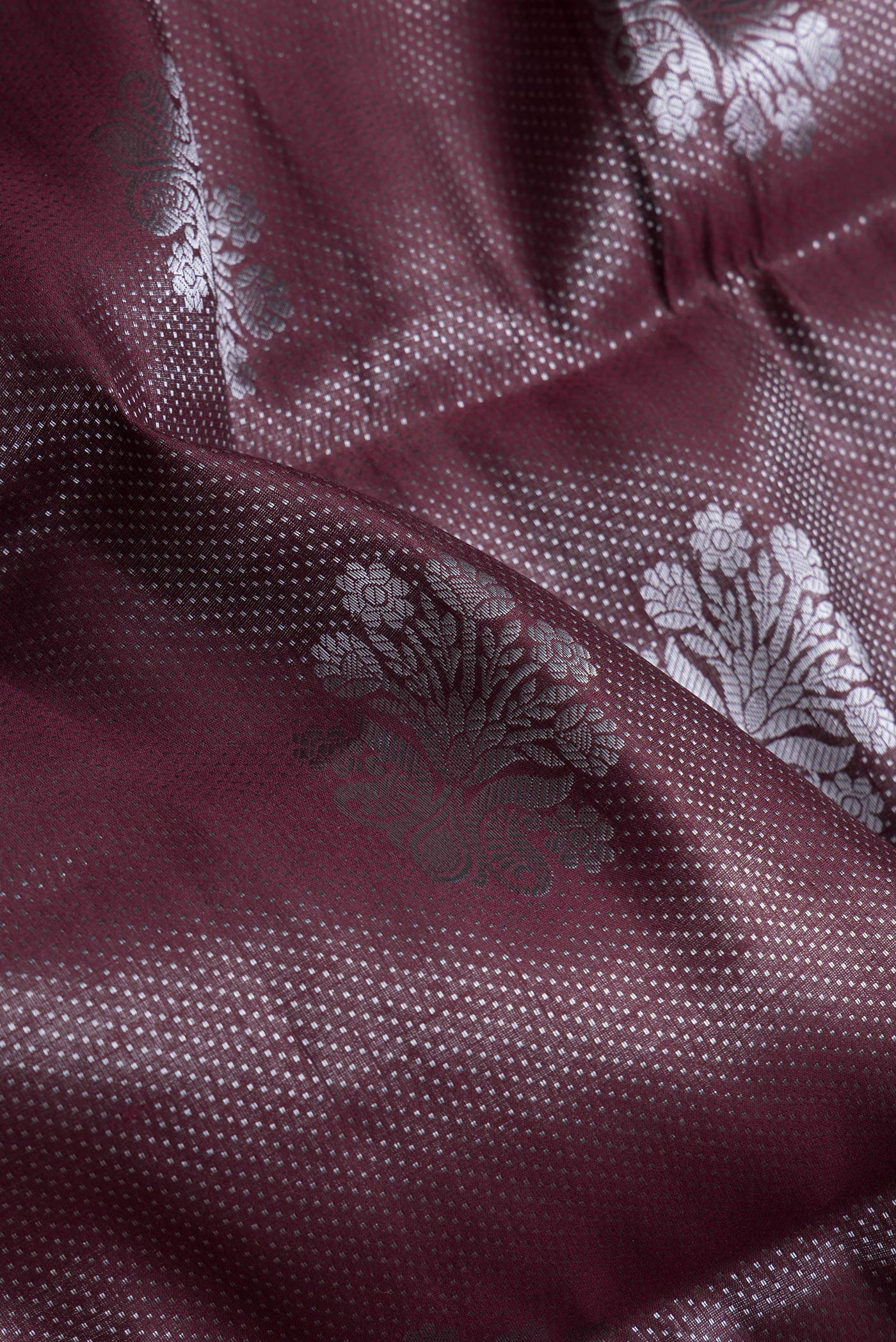 Close up of Maroon Dual Tone Tussar Silk Saree with Zari Brocade on the body and Zari Border.  displaying folds