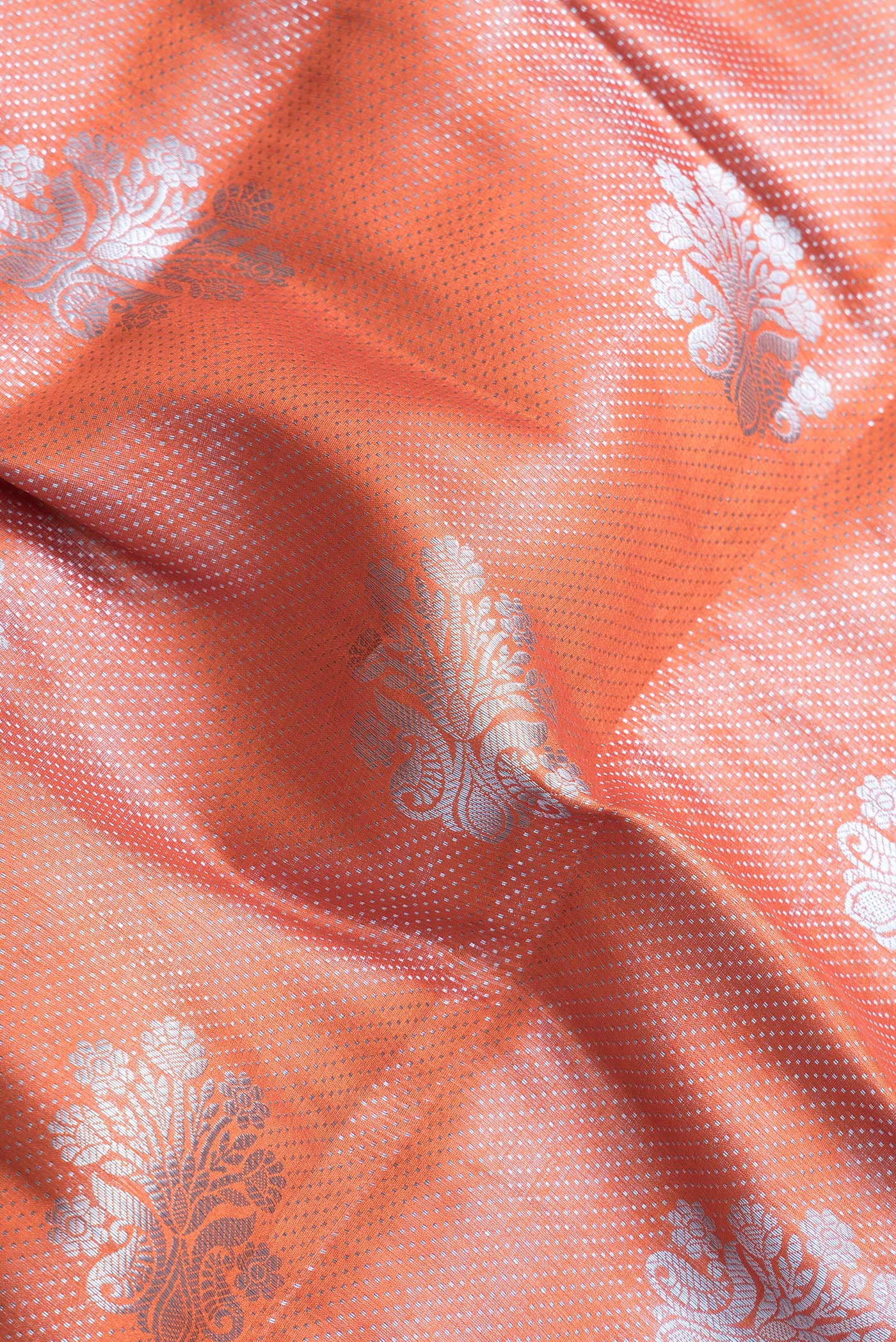 Close up of Orange Dual Tone Tussar Silk Saree with Zari Brocade on the body and Zari Border.  displaying folds