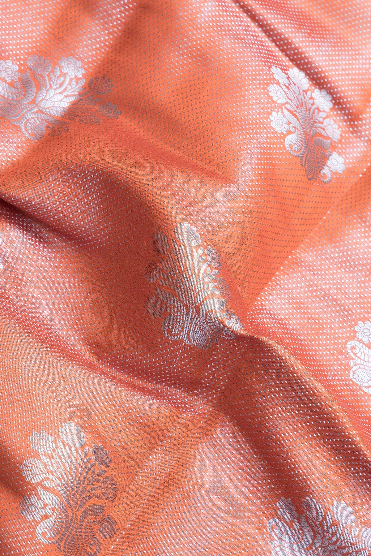 Close up of Orange Dual Tone Tussar Silk Saree with Zari Brocade on the body and Zari Border.  displaying folds