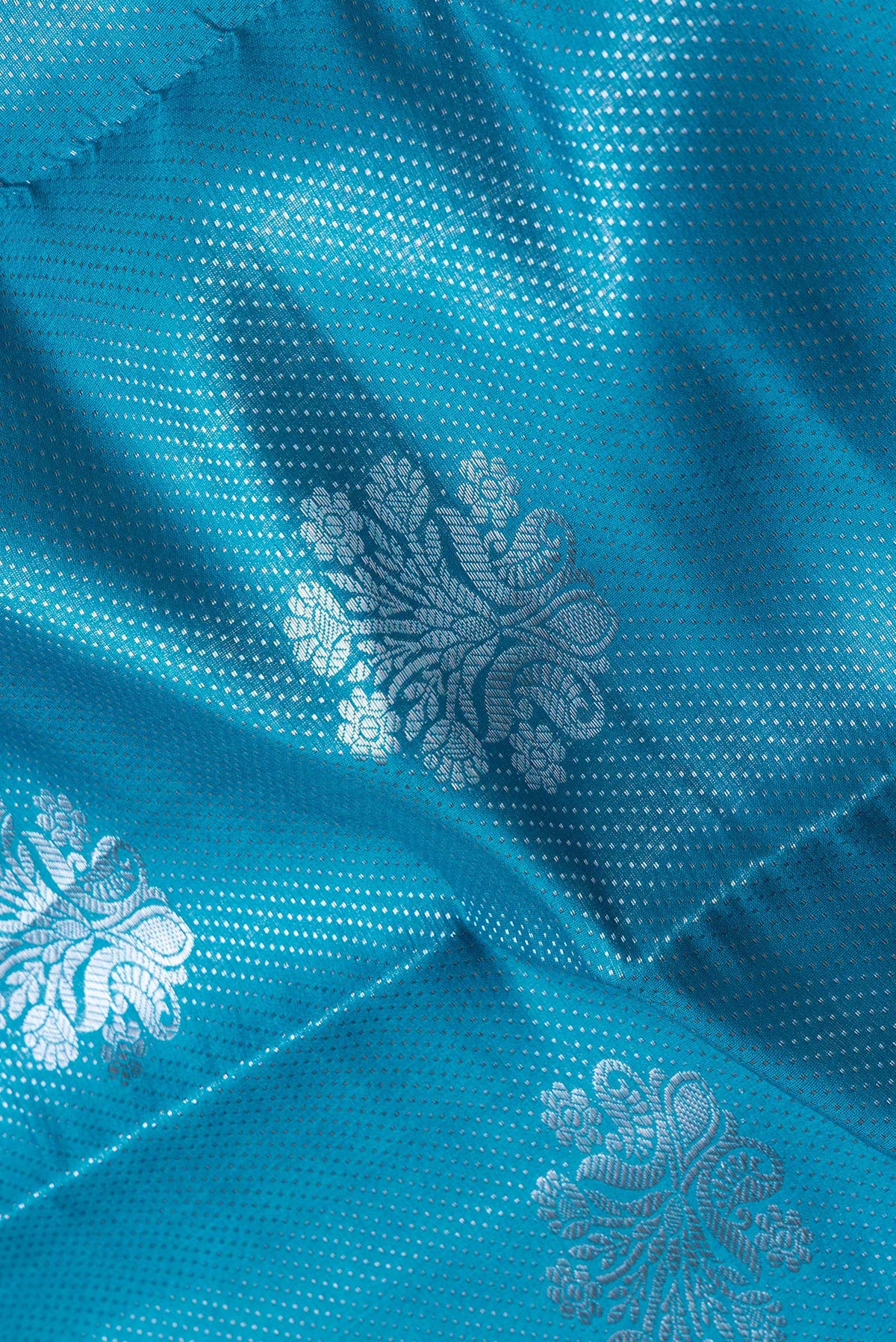 Close up of Sky Blue Dual Tone Tussar Silk Saree with Zari Brocade on the body and Zari Border.  displaying folds