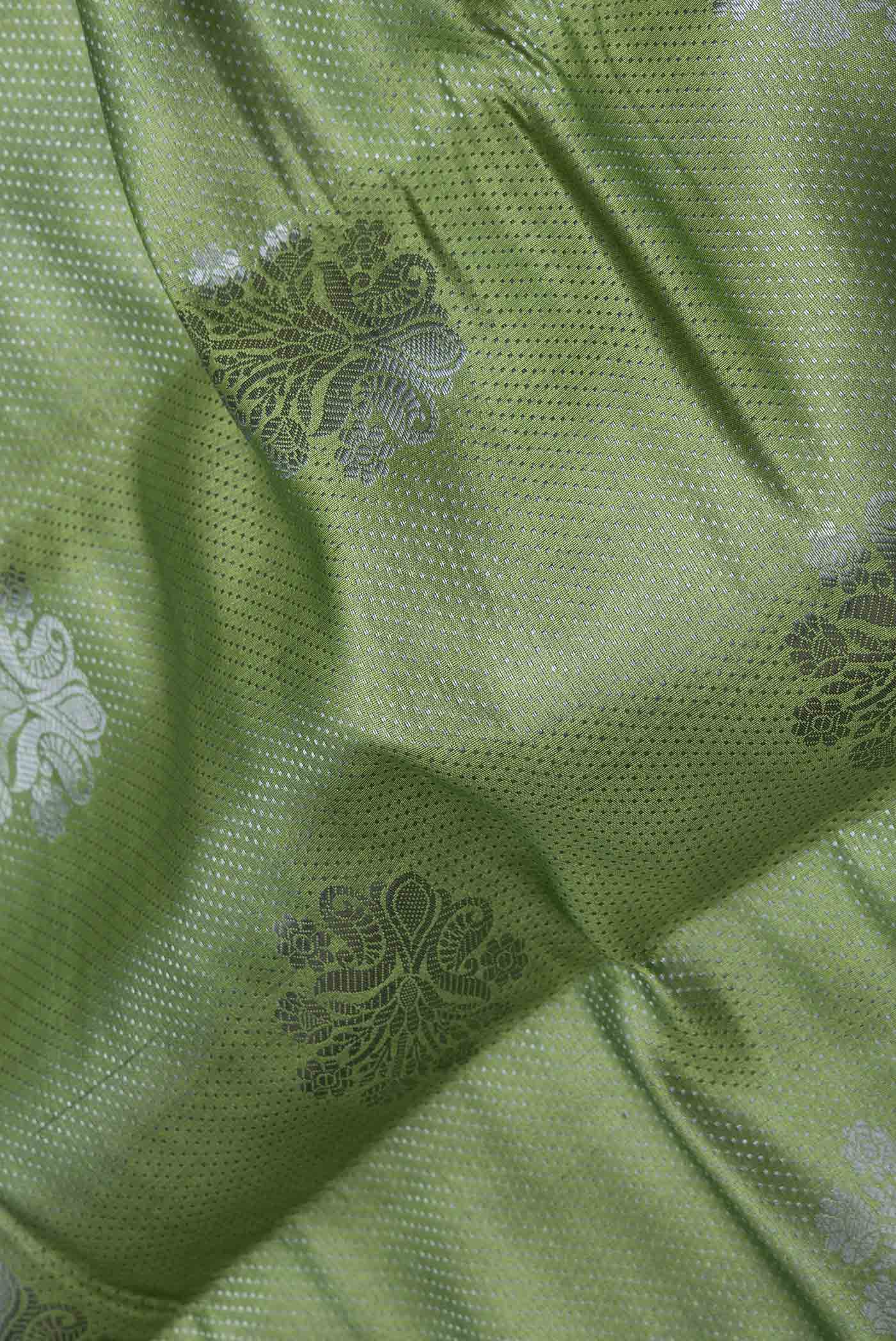 Close up of Green Dual Tone Tussar Saree with Zari Brocade on the body and Zari Border displaying folds