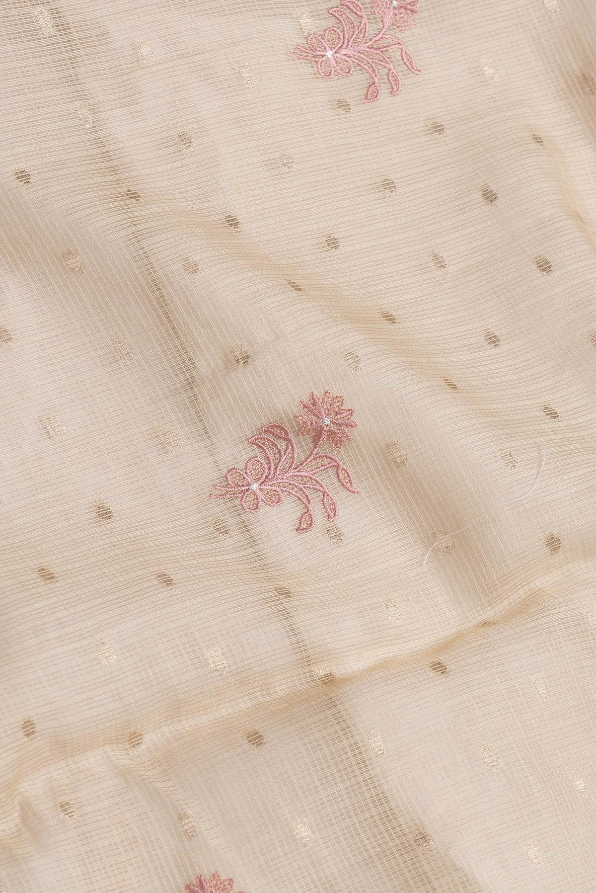 Close up of Beige Dual Tone Kota Silk Saree with Embroidery on the body and Without Border.  displaying folds