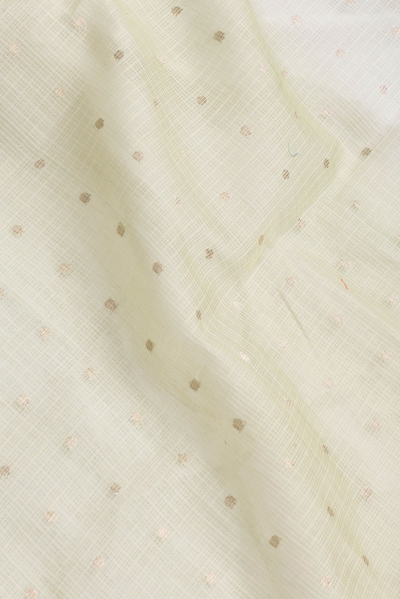 Close up of Pista Green Dual Tone Kota Silk Saree with Zari Butta on the body and Without Border.  displaying folds