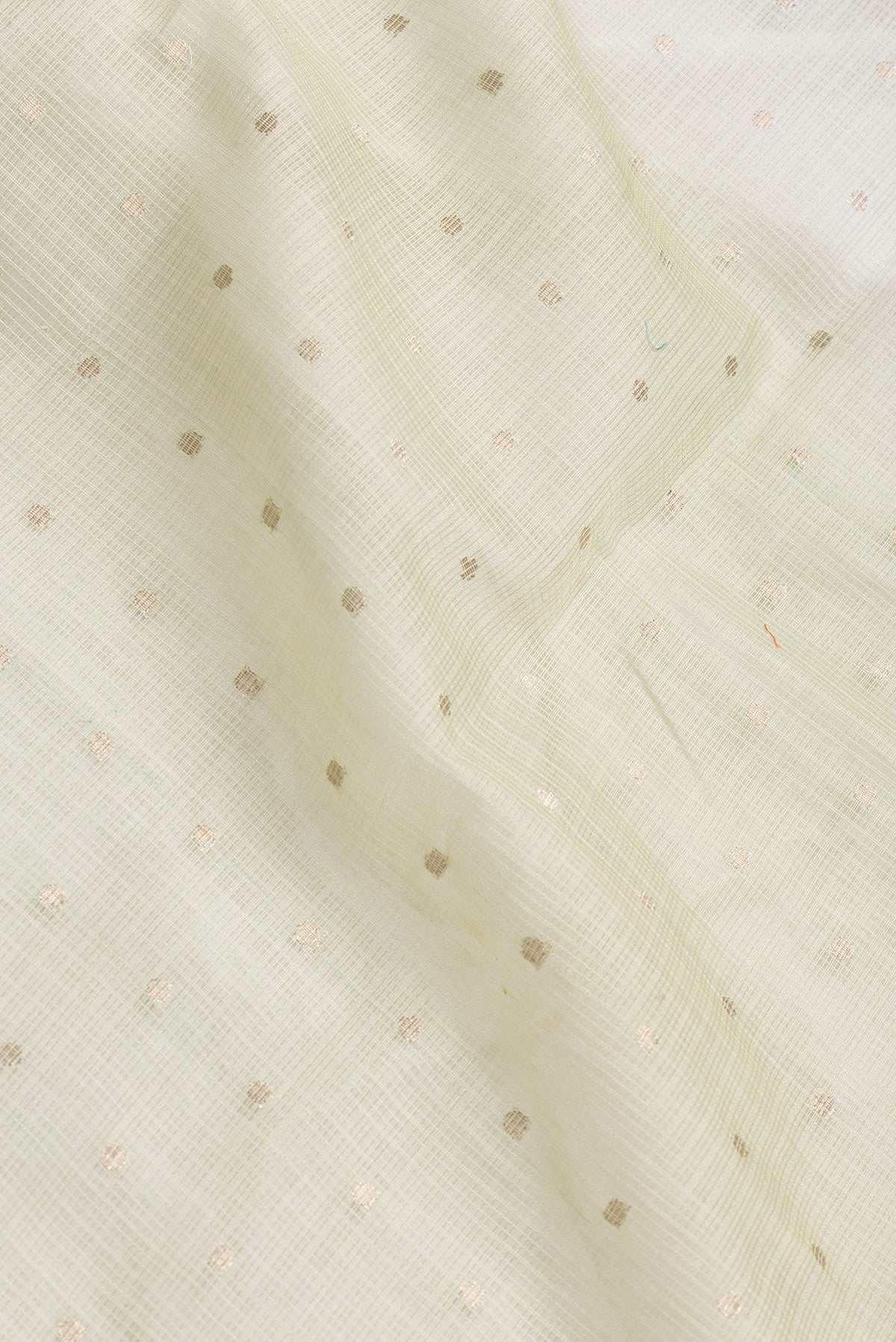 Close up of Pista Green Dual Tone Kota Silk Saree with Zari Butta on the body and Without Border.  displaying folds