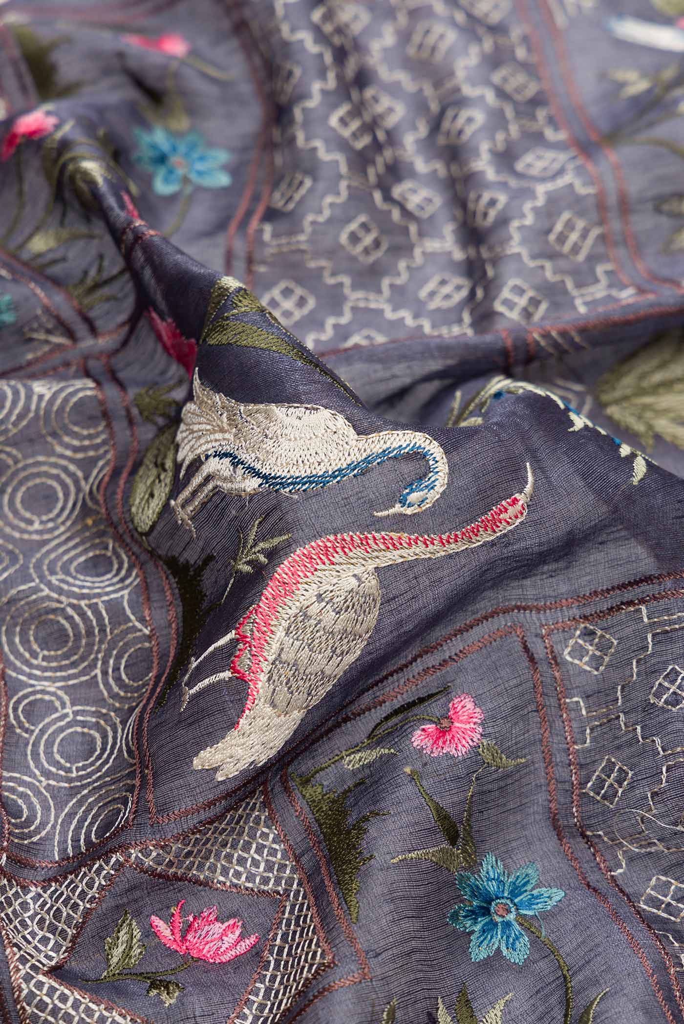 Close up of Blue Grey Dual Tone Tussar Silk Saree with Embroidery on the body and Embroidery Border.  displaying folds