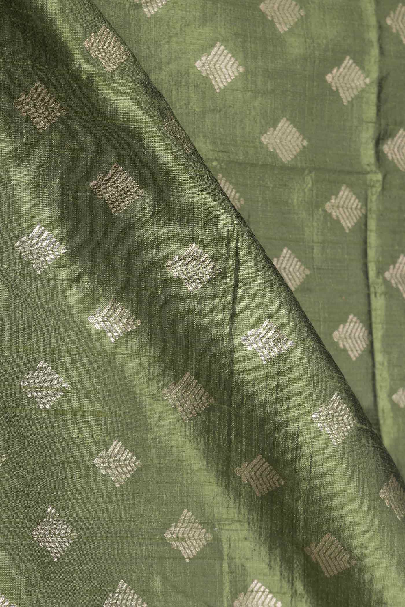 Close up of Green Dual Tone Raw Silk Saree with Zari Brocade on the body and Zari Border displaying folds