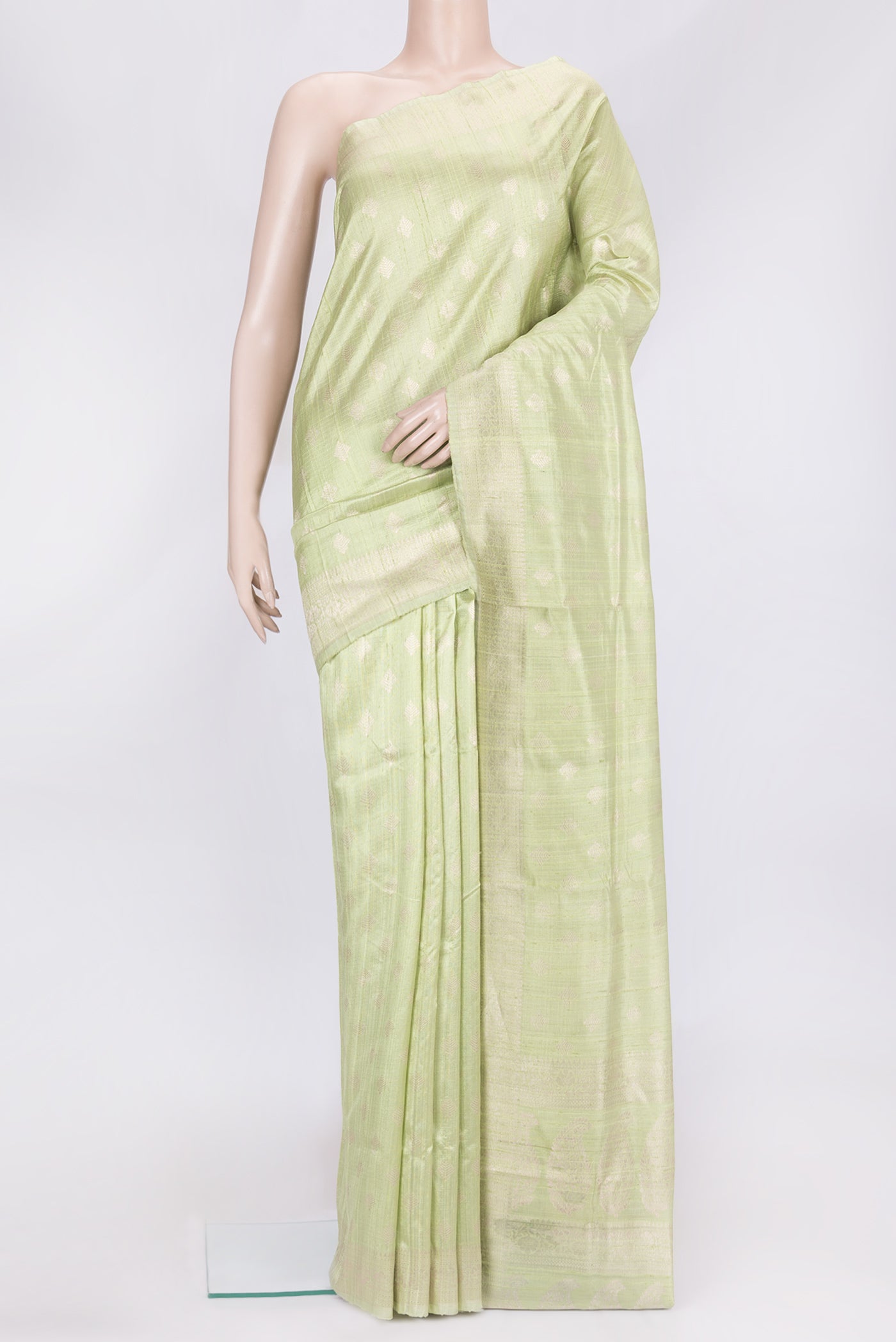Pista Green Dual Tone Raw Silk Saree with Zari Butta on the body and Zari Border.  displayed on a mannequin