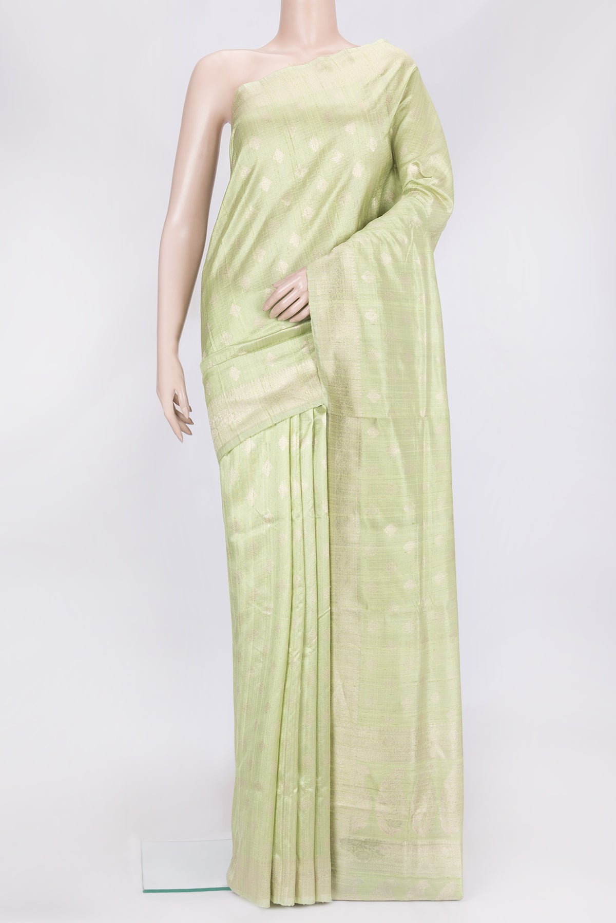 Pista Green Dual Tone Raw Silk Saree with Zari Butta on the body and Zari Border.  displayed on a mannequin