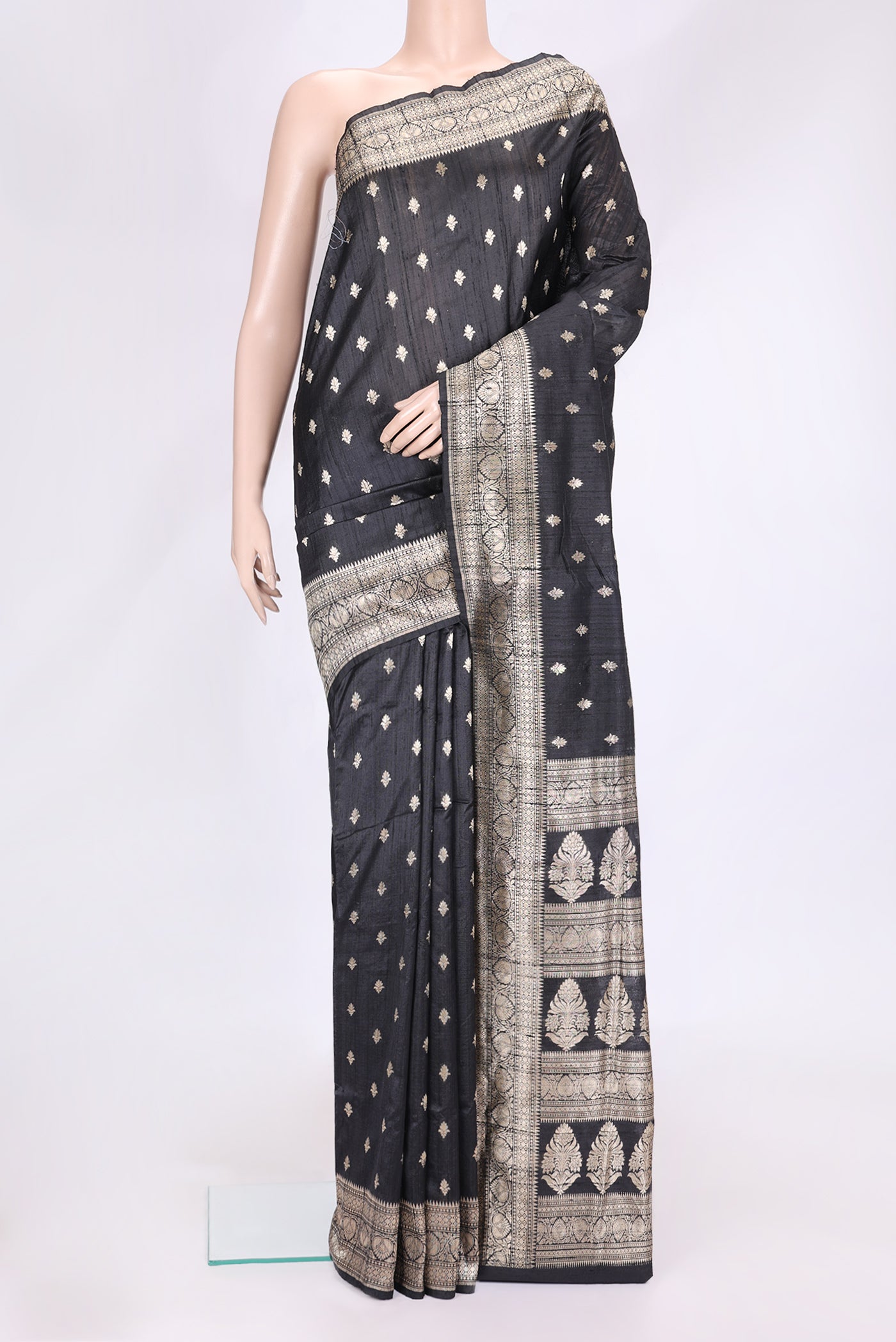Black Dual Tone Raw Silk Saree with Zari Butta on the body and Zari Border.  displayed on a mannequin