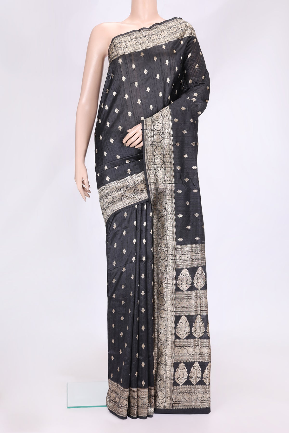 Black Dual Tone Raw Silk Saree with Zari Butta on the body and Zari Border.  displayed on a mannequin