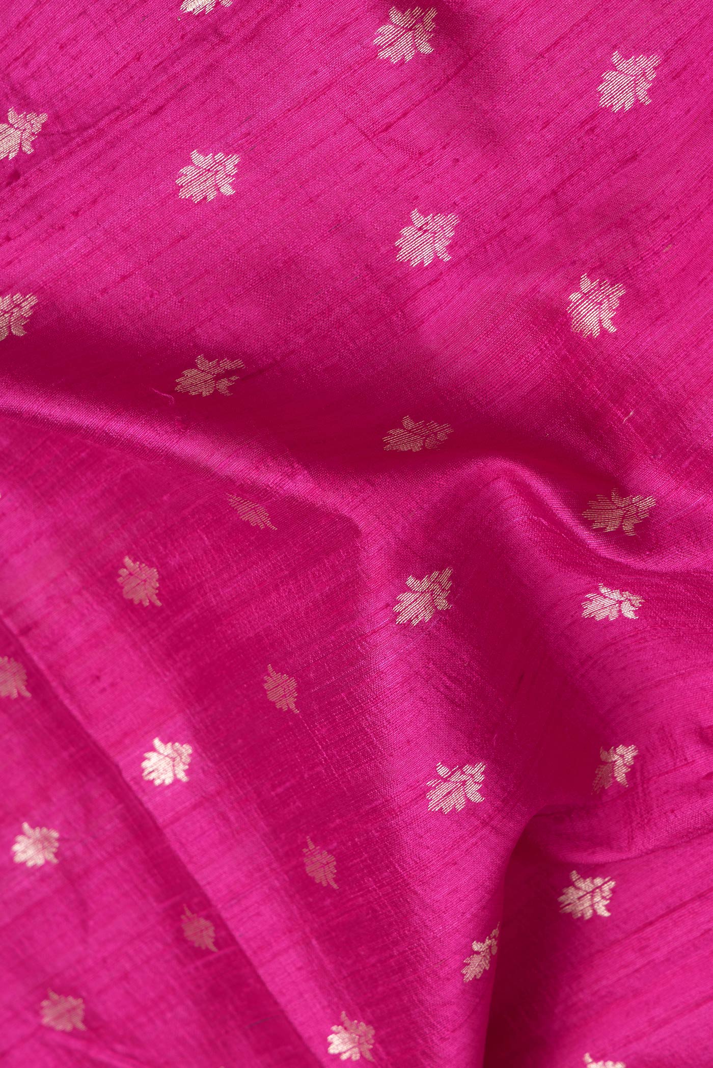 Close up of Pink Dual Tone Raw Silk Saree with Zari Butta on the body and Zari Border.  displaying folds