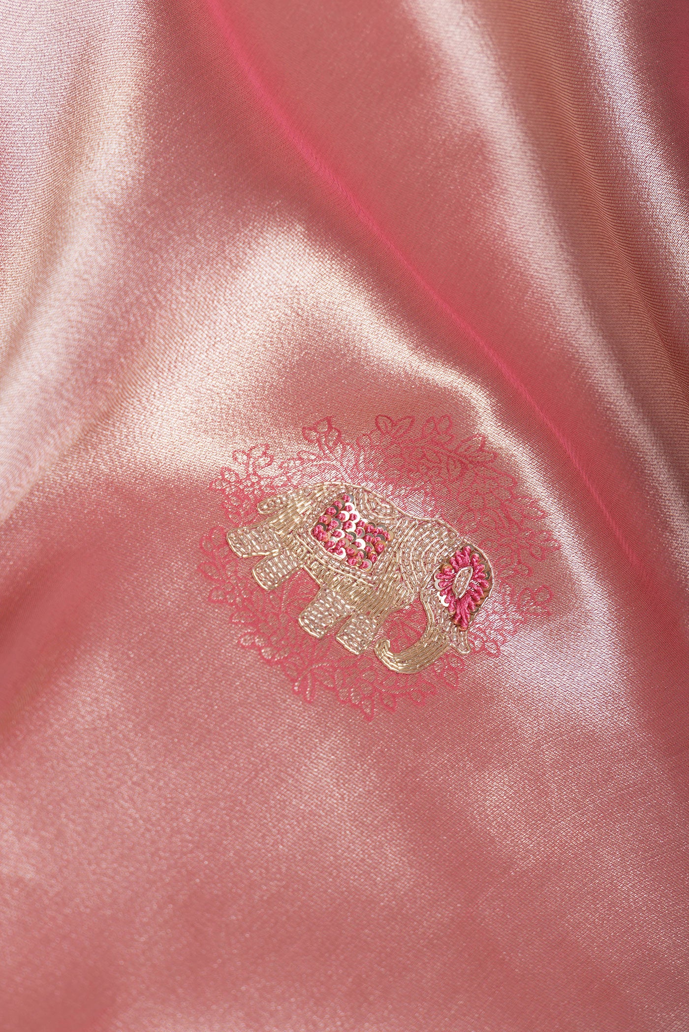 Close up of Rose Gold Dual Tone Banarasi Georgette Saree with Embroidery on the body and Embroidery Border.  displaying folds