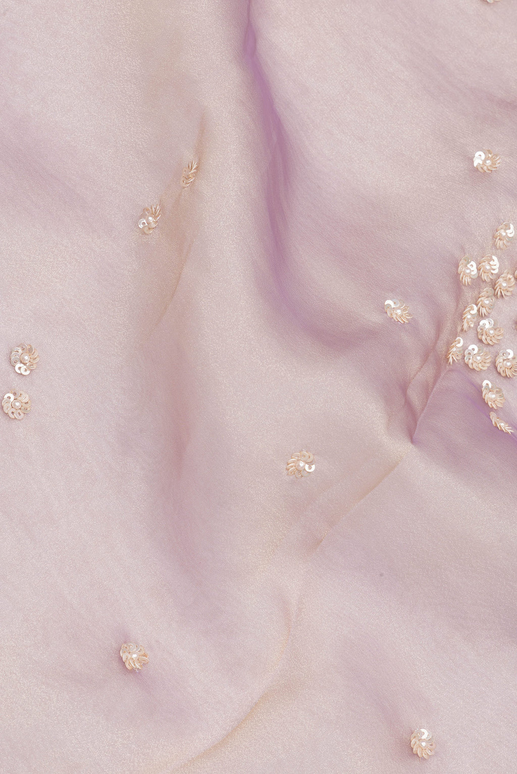 Close up of Lavender Dual Tone Organza Saree with Embroidery on the body and Sequin Border.  displaying folds