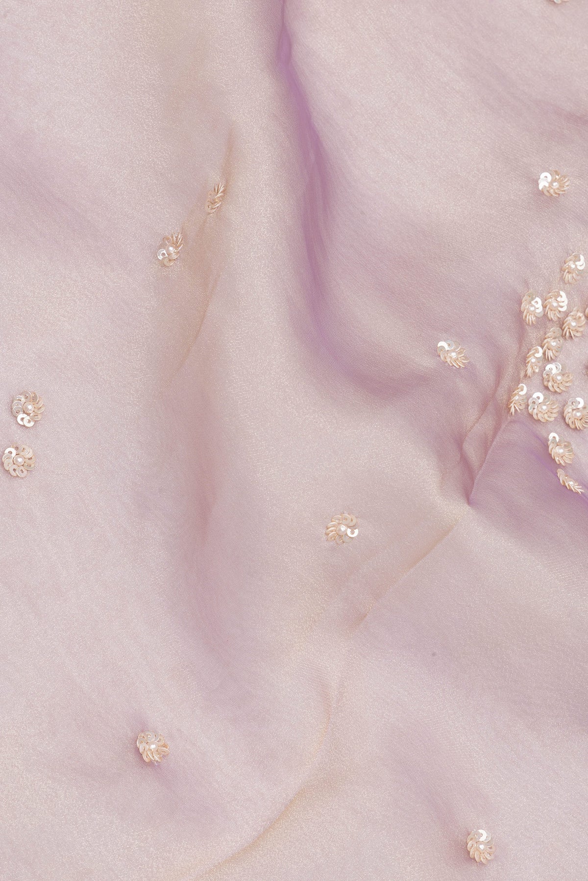 Close up of Lavender Dual Tone Organza Saree with Embroidery on the body and Sequin Border.  displaying folds