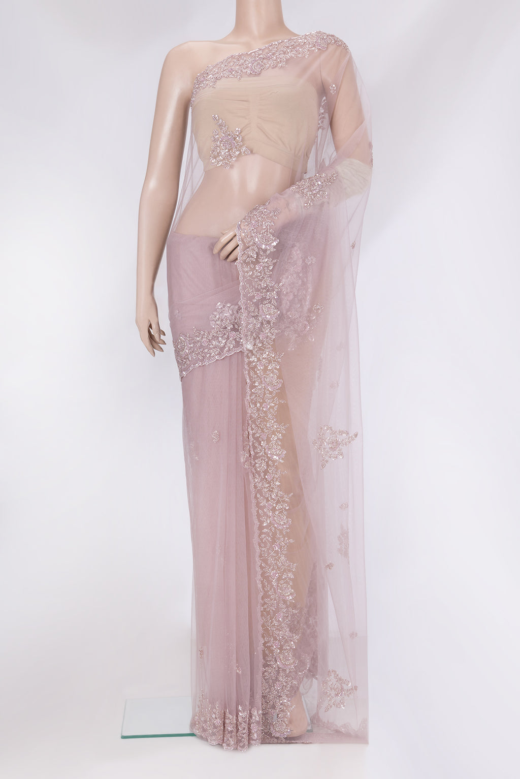 Lavender Embroidery Net Saree with Embroidery on the body and Sequin Border.  displayed on a mannequin