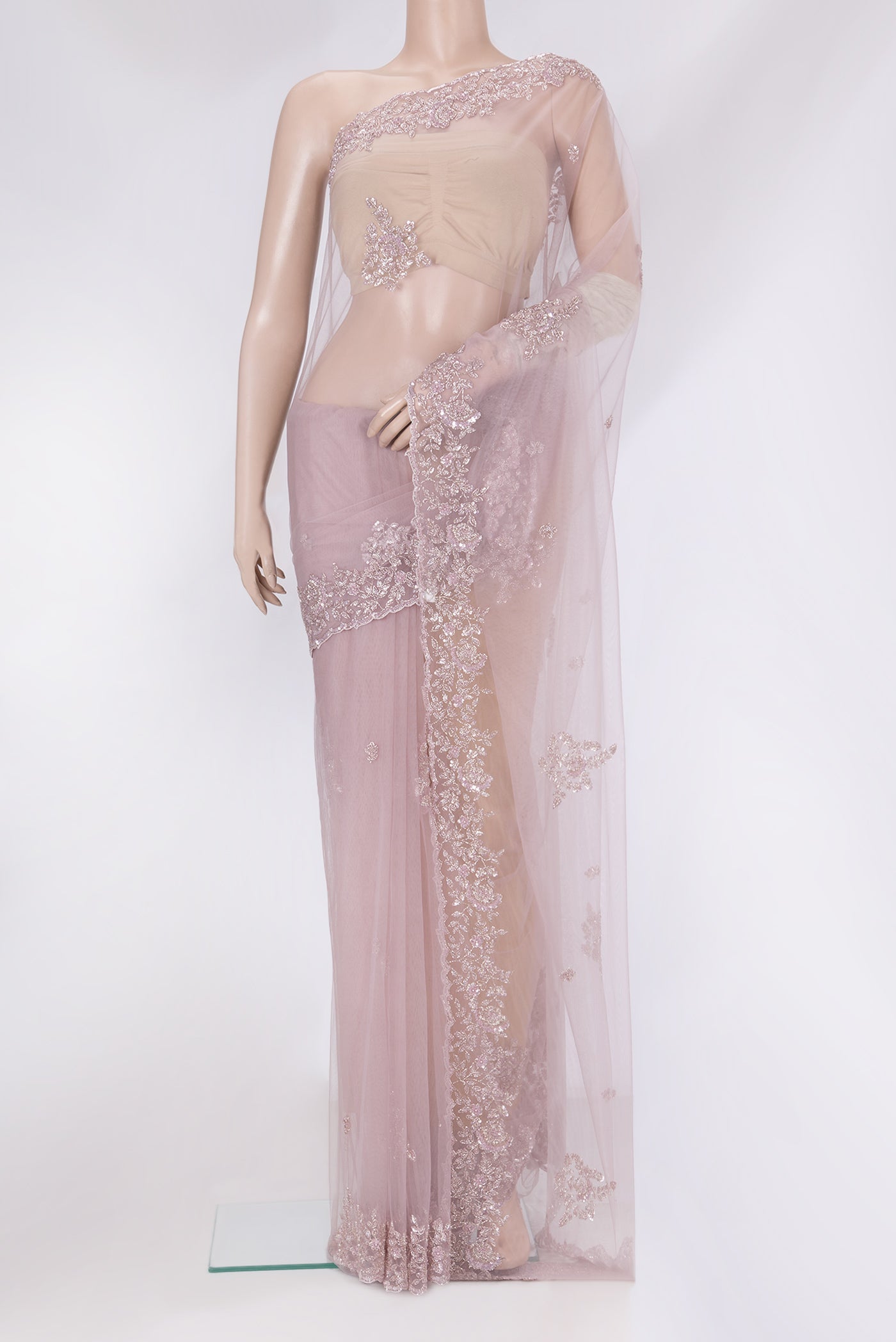 Lavender Embroidery Net Saree with Embroidery on the body and Sequin Border.  displayed on a mannequin