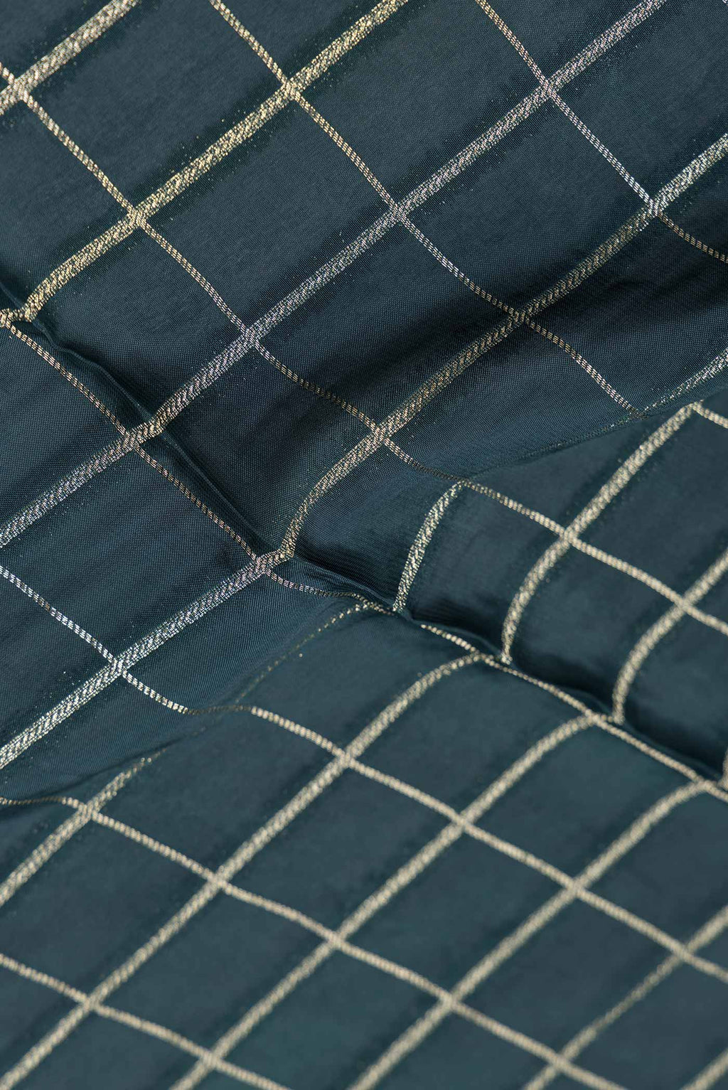 Close up of Bottle Green Dual Tone Banarasi Silk Saree with Checked design on the body and Fancy Border.  displaying folds