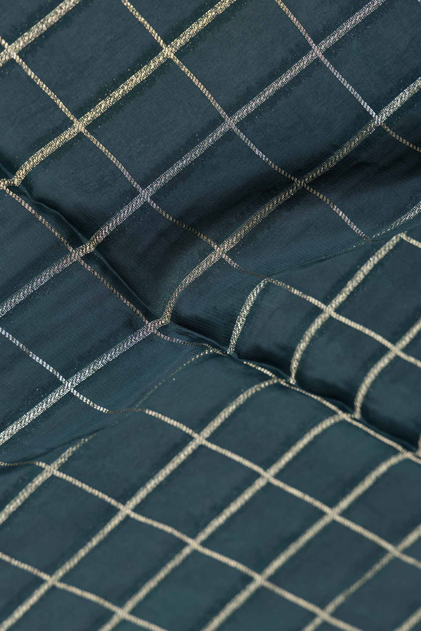 Close up of Bottle Green Dual Tone Banarasi Silk Saree with Checked design on the body and Fancy Border.  displaying folds