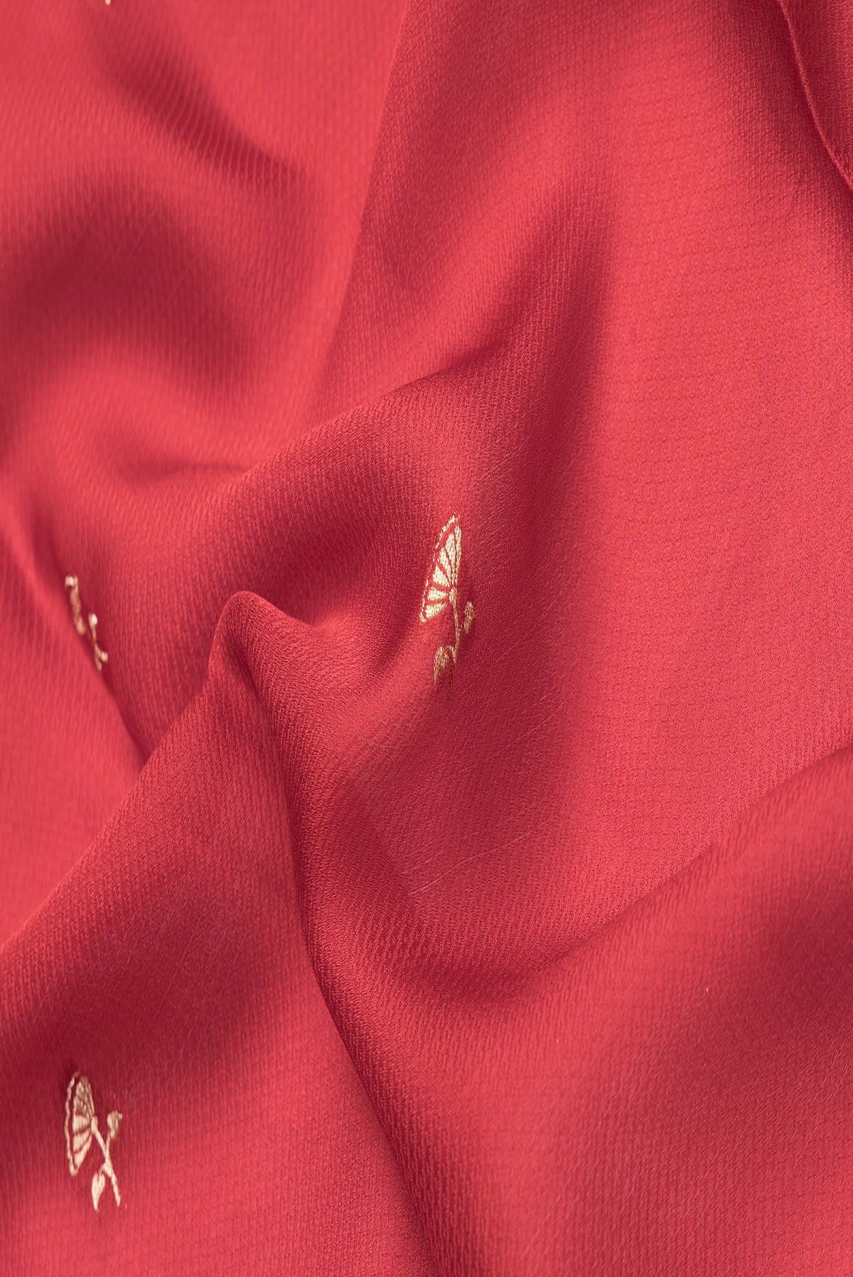 Close up of Maroon Dual Tone Banarasi Georgette Saree with Embroidery on the body and Fancy Border.  displaying folds