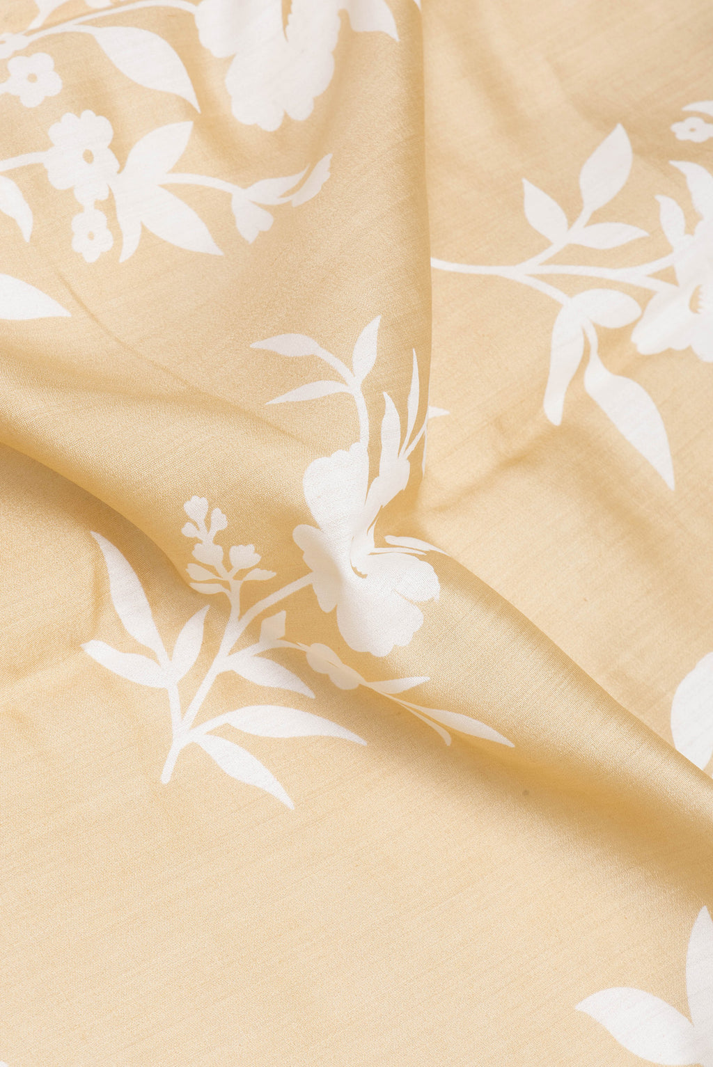 Close up of Sandal Chanderi Silk Saree with Printed design on the body and Zari Border.  displaying folds
