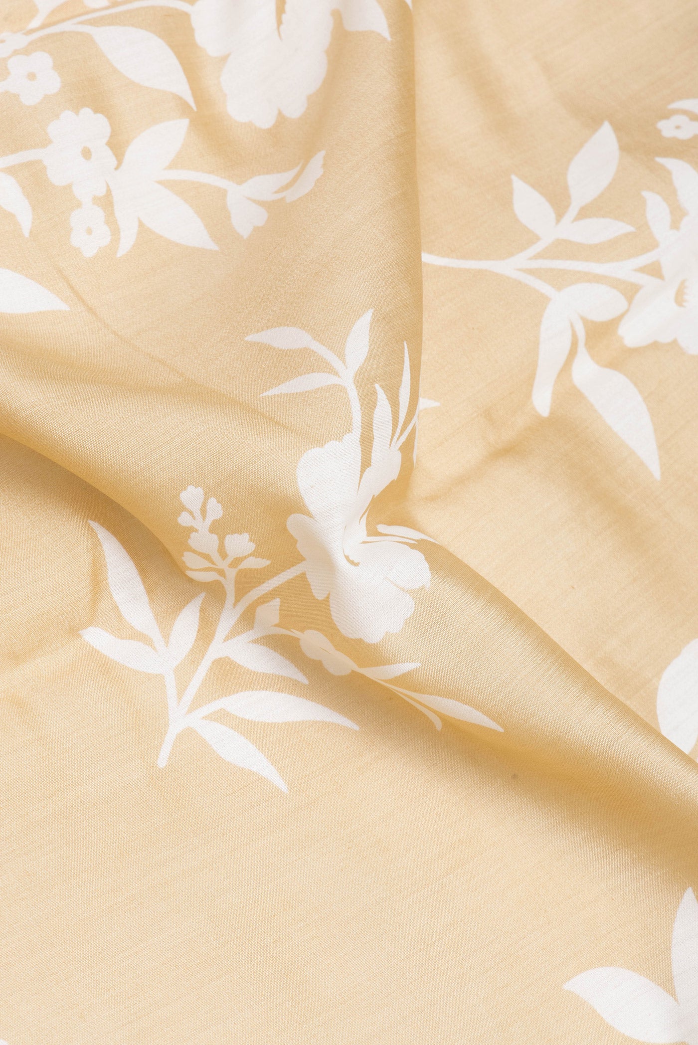 Close up of Sandal Chanderi Silk Saree with Printed design on the body and Zari Border.  displaying folds