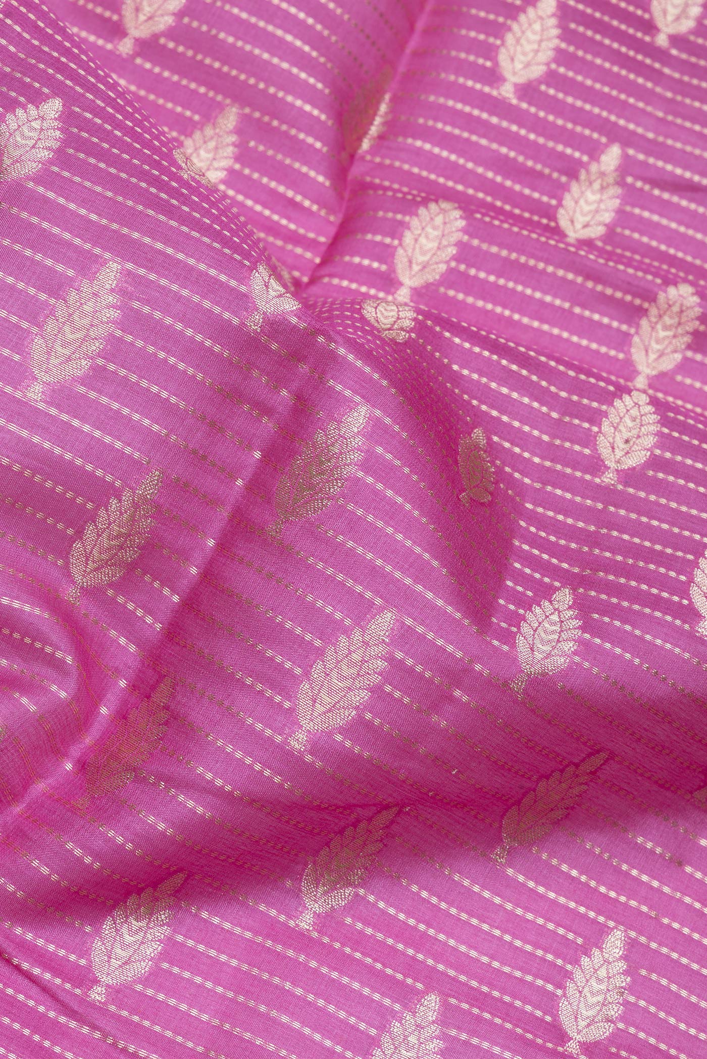 Close up of Lavender Tussar Silk Saree with Zari Butta on the body and Zari Border.  displaying folds