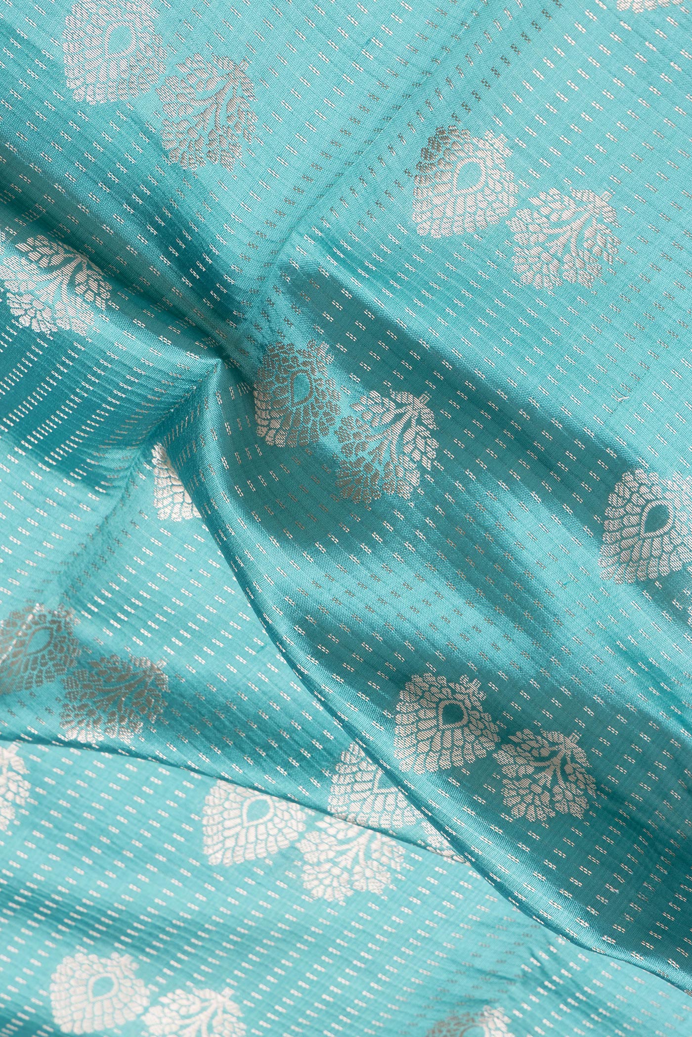 Close up of Light Blue Dual Tone Banarasi Raw Silk Saree with Zari Brocade on the body and Zari Border.  displaying folds