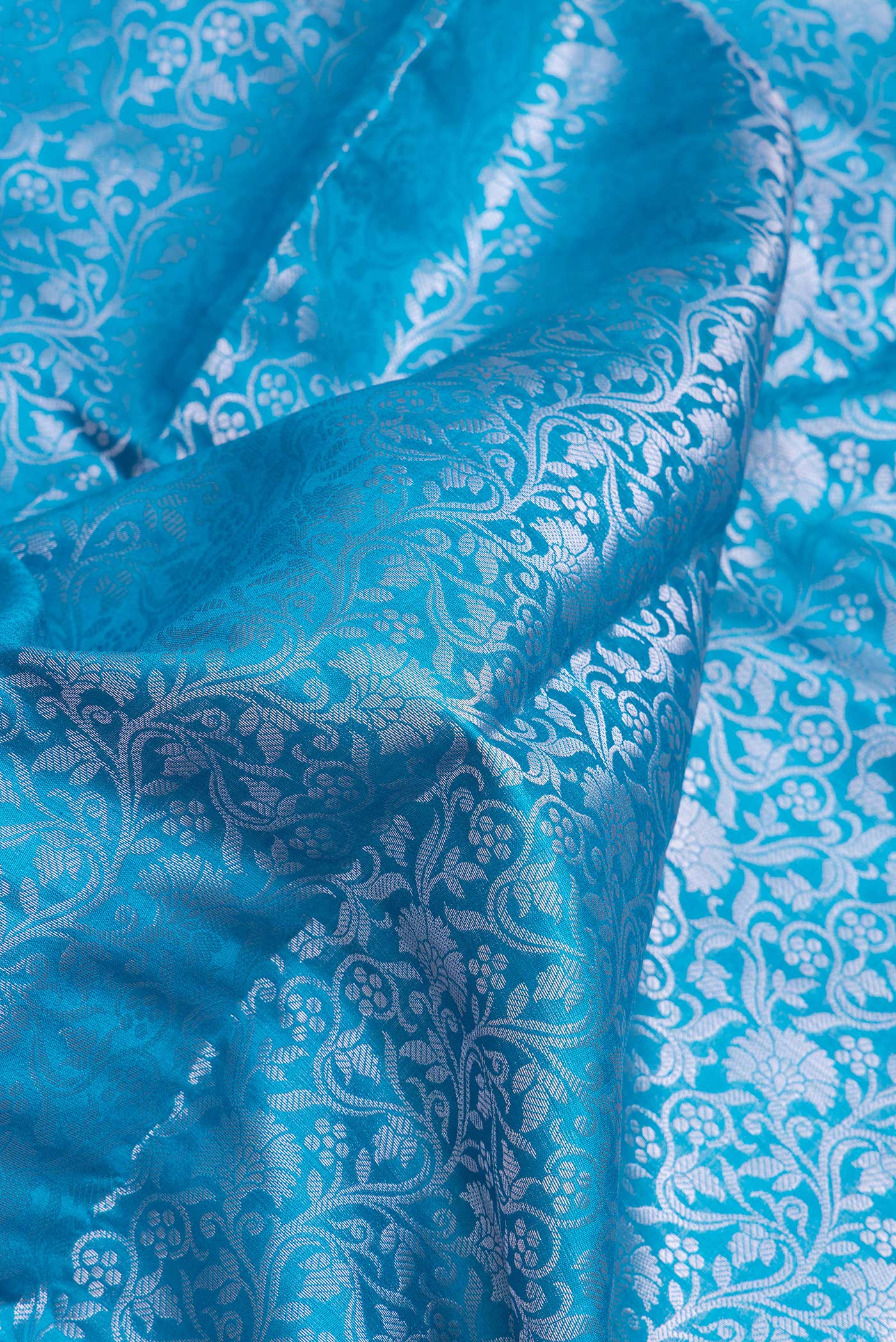 Close up of Sky Blue Dual Tone Tussar Silk Saree with Zari Brocade on the body and Zari Border.  displaying folds