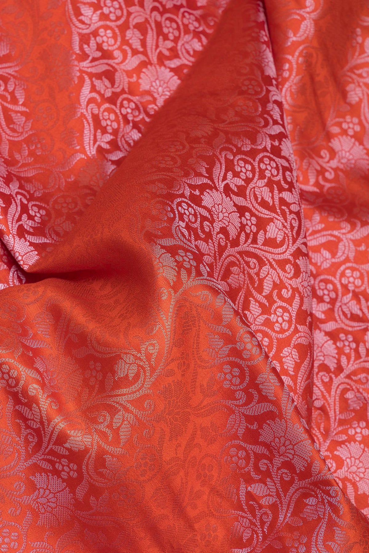 Close up of Orange Tussar Silk Saree with Zari Brocade on the body and Zari Border.  displaying folds