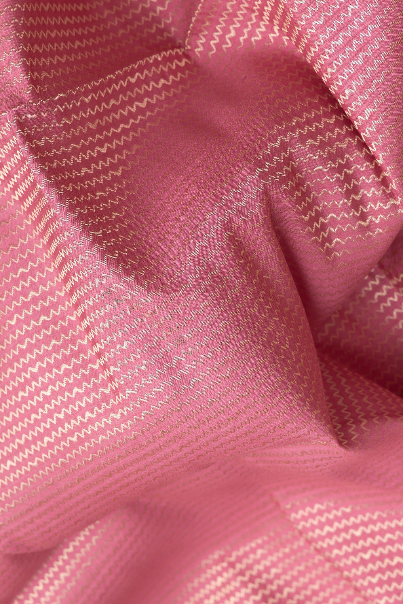 Close up of Pink Dual Tone Banarasi Raw Silk Saree with Zari Brocade on the body and Zari Border.  displaying folds