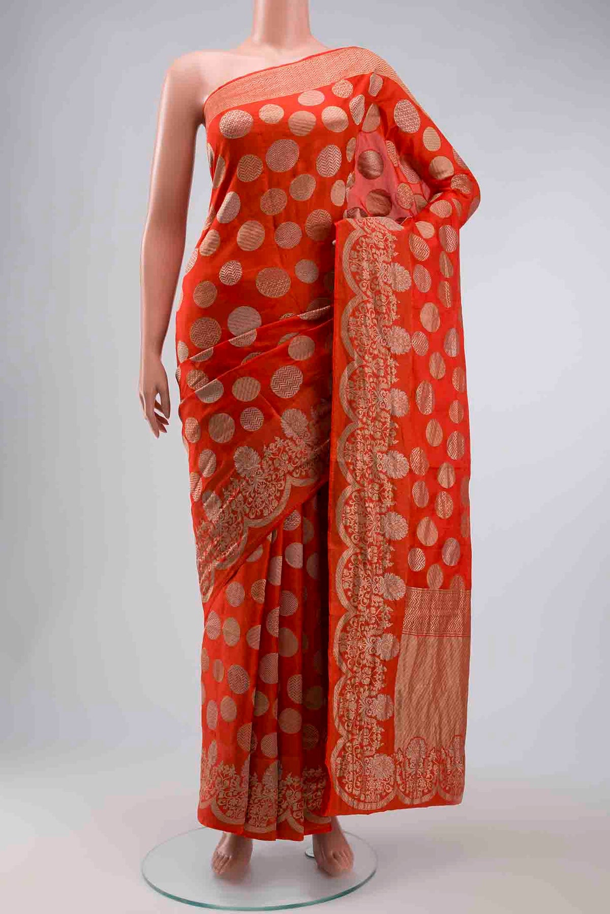 Orange Banarasi Silk Saree with Zari Butta on the body and Zari Border displayed on a mannequin