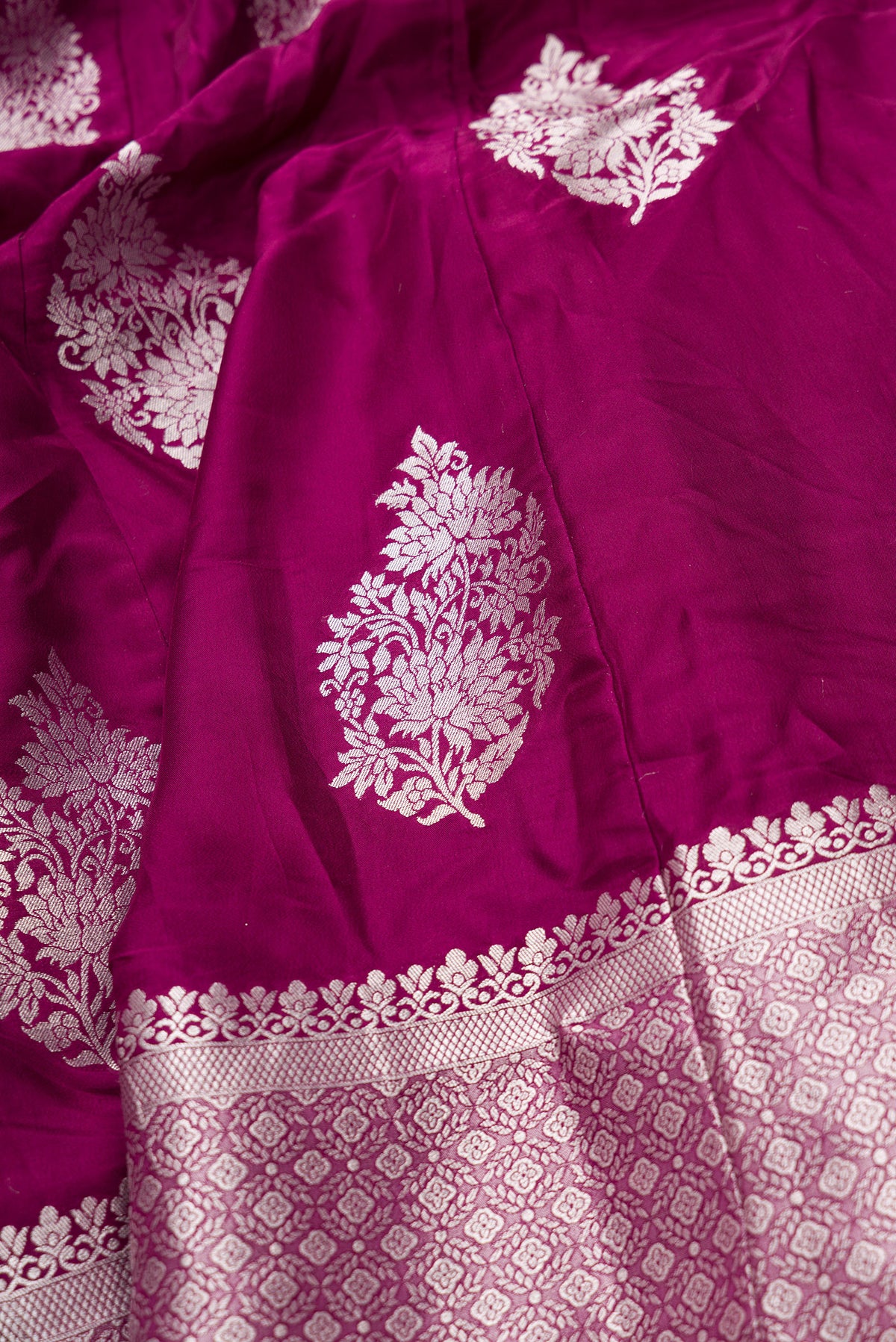 Detailed shot of Burgundy Banarasi Silk Womens Lehenga set featuring Zari Brocade Choli paired with Burgundy Zari Brocade Skirt with Zari Border and a Zari Butta dupatta in Burgundy