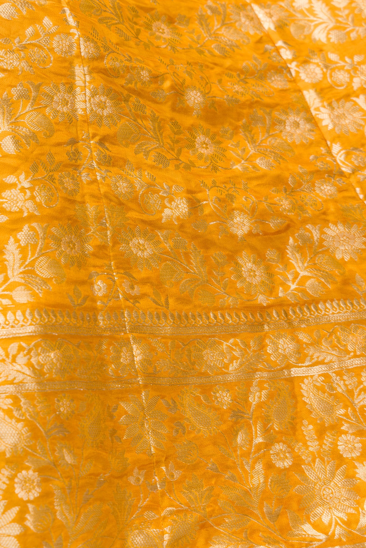 Detailed shot of Mustard Banarasi Silk Womens Lehenga set featuring Zari Brocade Choli paired with Mustard Zari Brocade Skirt with Zari Border and a Zari Brocade dupatta in Mustard