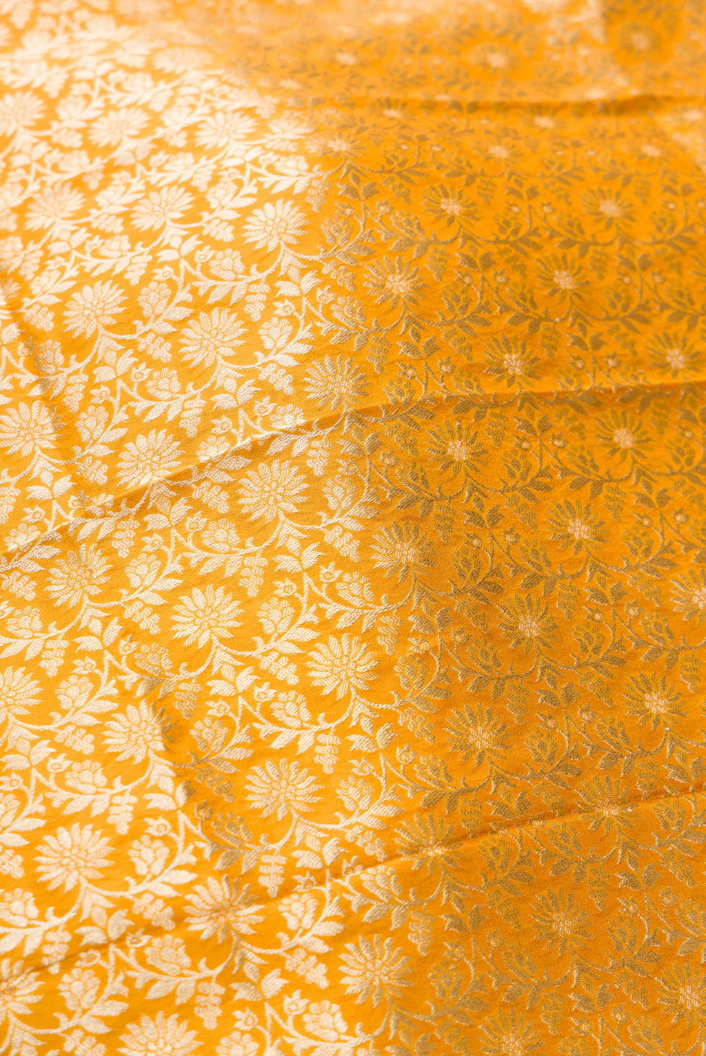 Close up blouse image of Mustard Banarasi Silk Womens Lehenga set featuring Zari Brocade Choli paired with Mustard Zari Brocade Skirt with Zari Border and a Zari Brocade dupatta in Mustard
