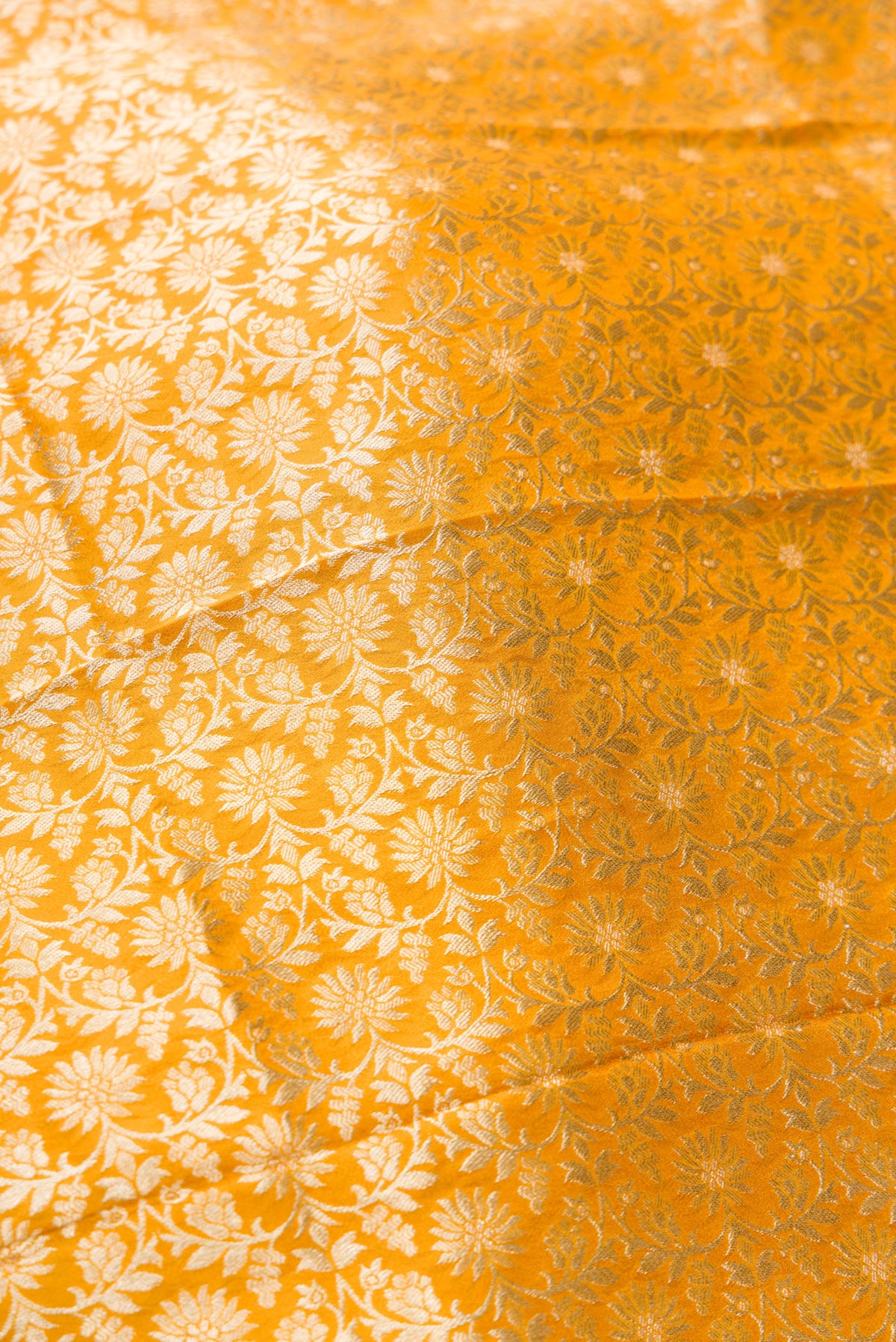 Close up blouse image of Mustard Banarasi Silk Womens Lehenga set featuring Zari Brocade Choli paired with Mustard Zari Brocade Skirt with Zari Border and a Zari Brocade dupatta in Mustard