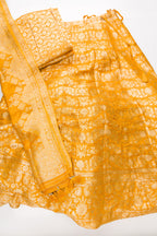 Flat lay of Mustard Banarasi Silk Womens Lehenga set featuring Zari Brocade Choli paired with Mustard Zari Brocade Skirt with Zari Border and a Zari Brocade dupatta in Mustard