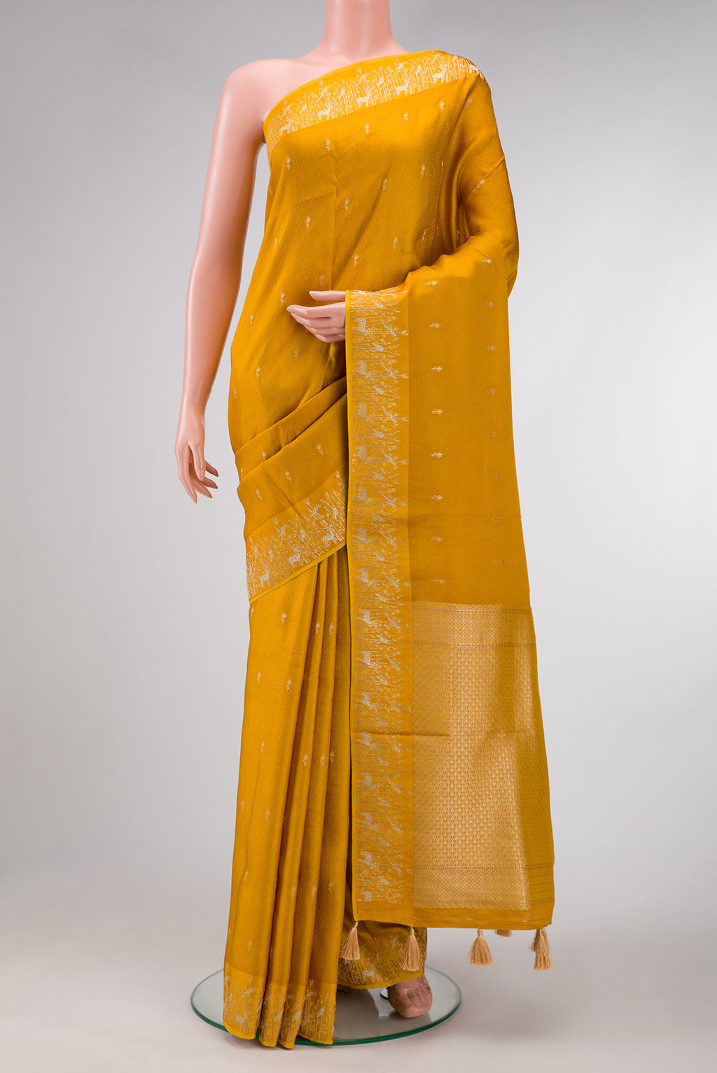 Mustard Dual Tone Mysore Crepe Saree with Zari Butta on the body and Fancy Border.  displayed on a mannequin