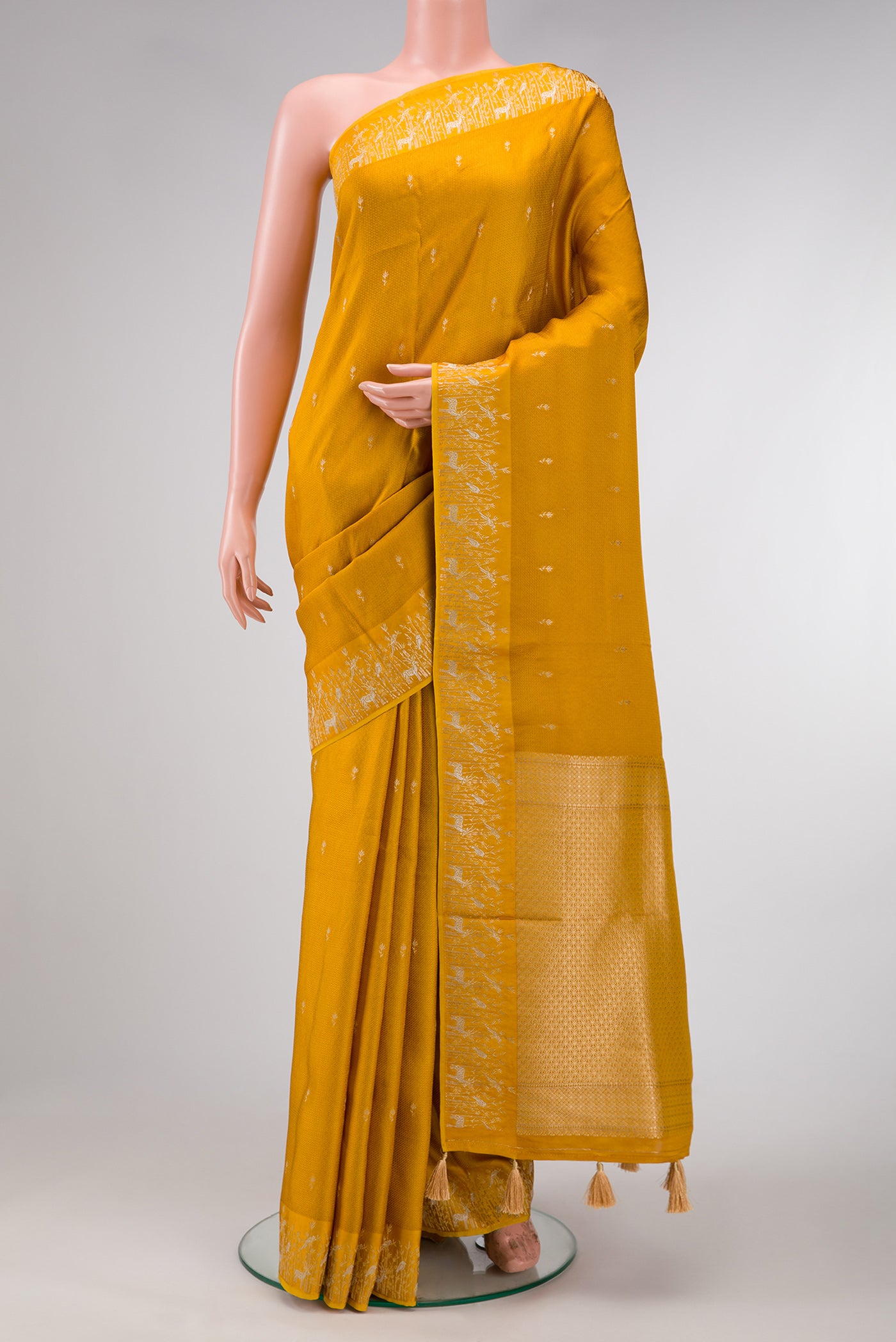 Mustard Dual Tone Mysore Crepe Saree with Zari Butta on the body and Fancy Border.  displayed on a mannequin