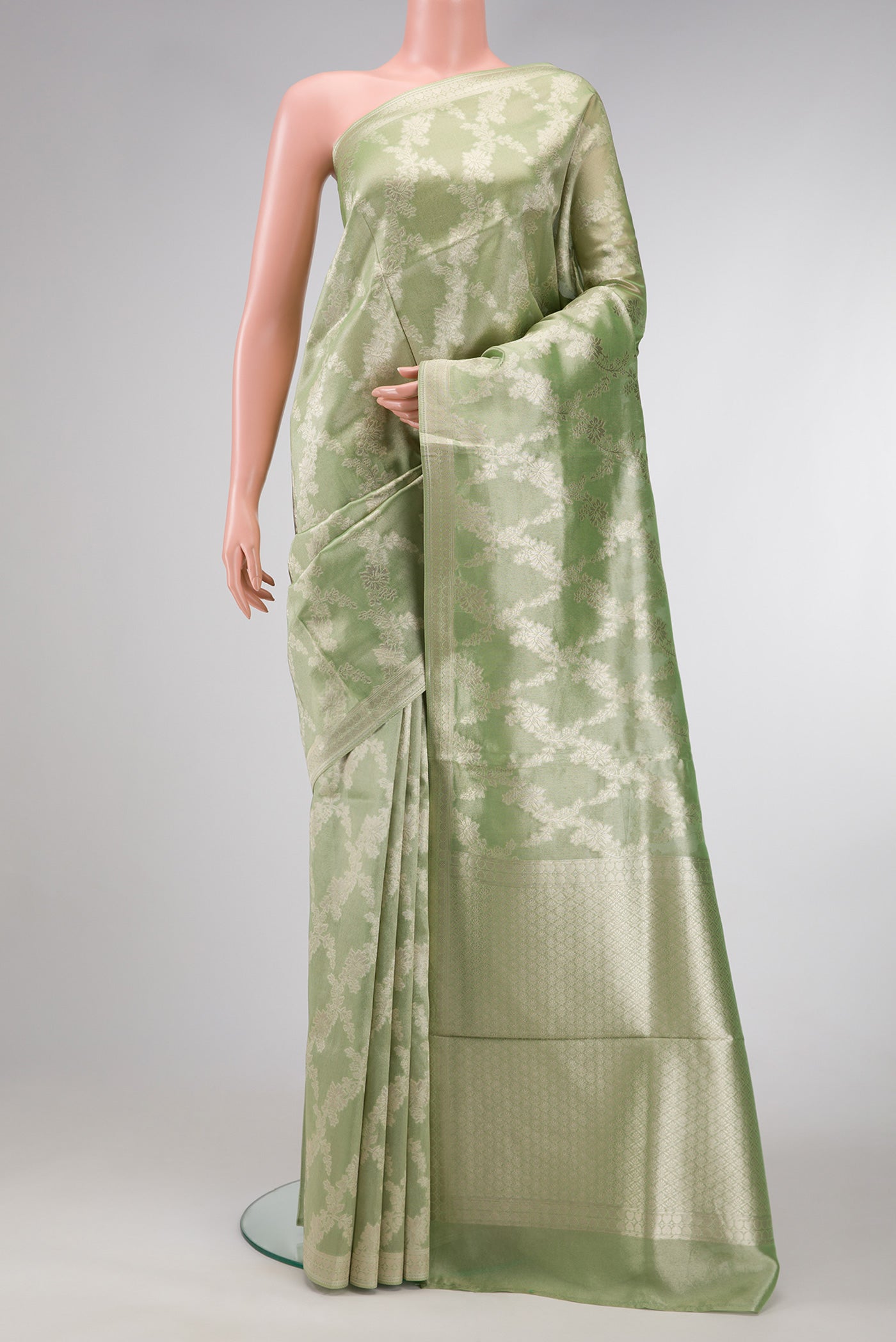 Pista Green Dual Tone Organza Silk Saree with Zari Brocade on the body and Zari Border.  displayed on a mannequin