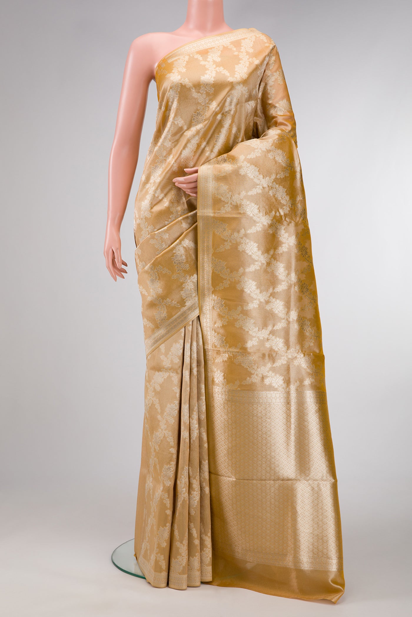 Gold Dual Tone Organza Silk Saree with Zari Brocade on the body and Zari Border.  displayed on a mannequin