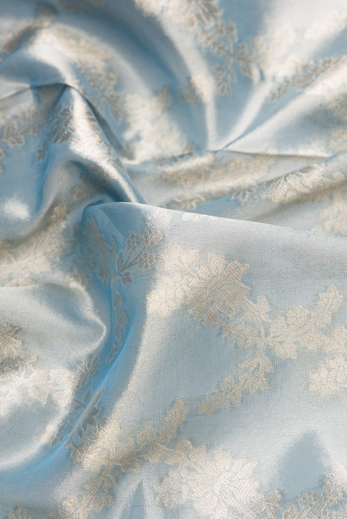 Close up of Maya Blue Dual Tone Organza Silk Saree with Zari Brocade on the body and Zari Border.  displaying folds