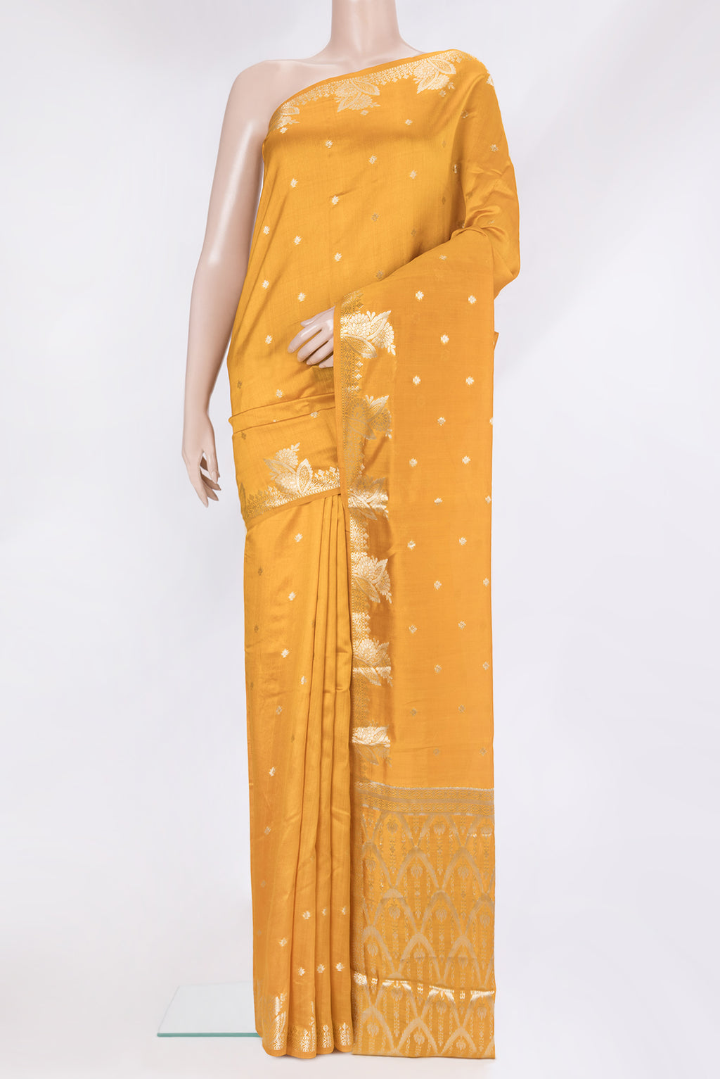 Mustard Tussar Silk Saree with Zari Butta on the body and Fancy Border.  displayed on a mannequin